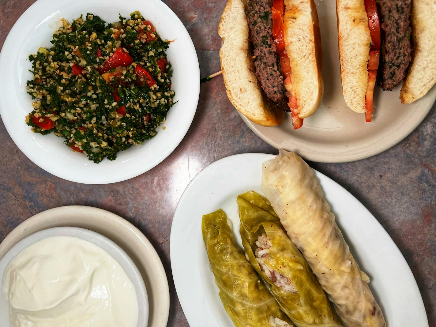 A spread from Emily's Lebanese Deli includes tabbouleh, cabbage rolls and the Kafta burger. Jon Cheng, Star Tribune