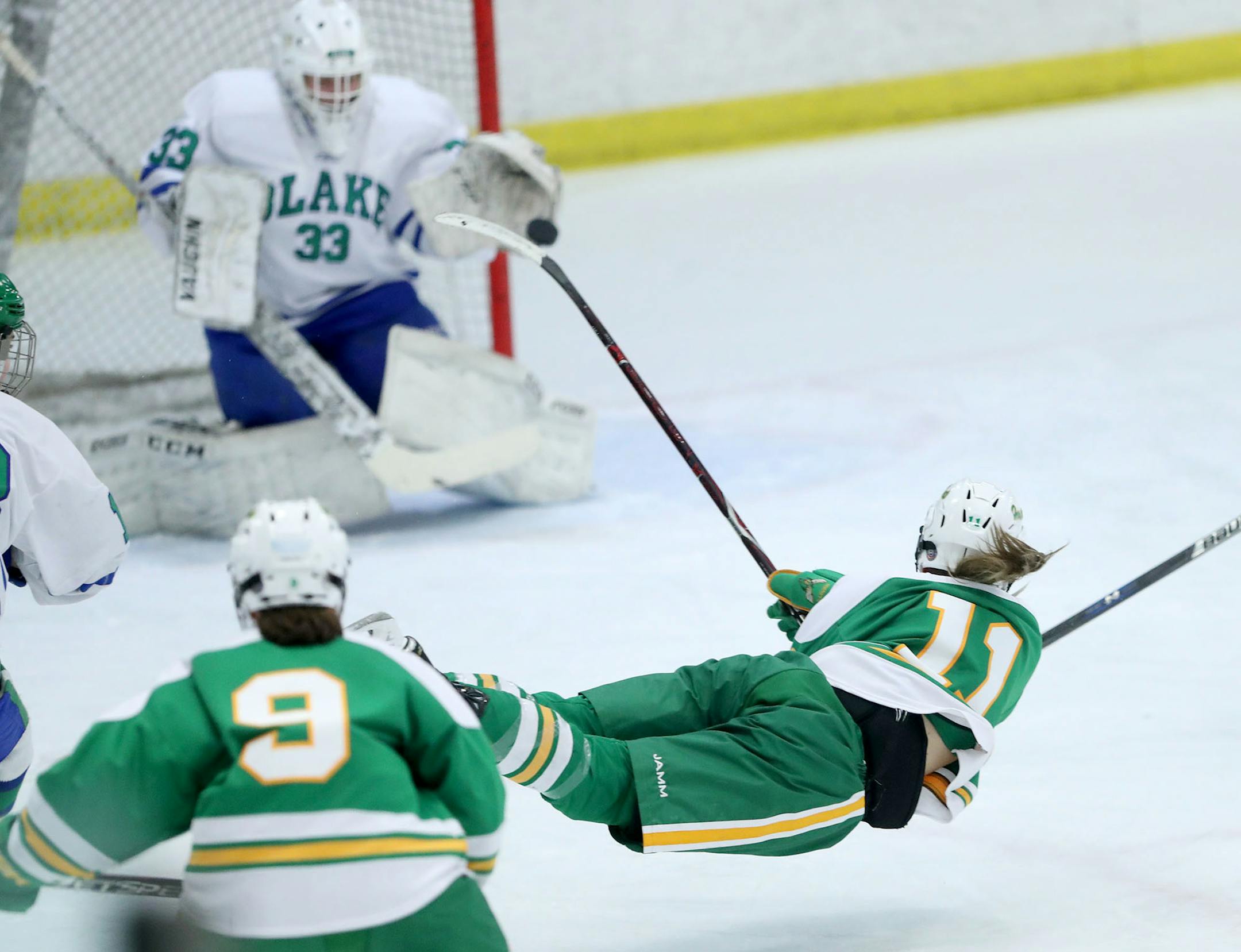 Edina's Annie Kuehl flew through the air after shooting against Blake goalie Molly Haag during the second period of their Class 2A, Section 6 girls' hockey final Friday at Parade Ice Garden. Edina won 3-2 and is shooting for its third consecutive state title this week.