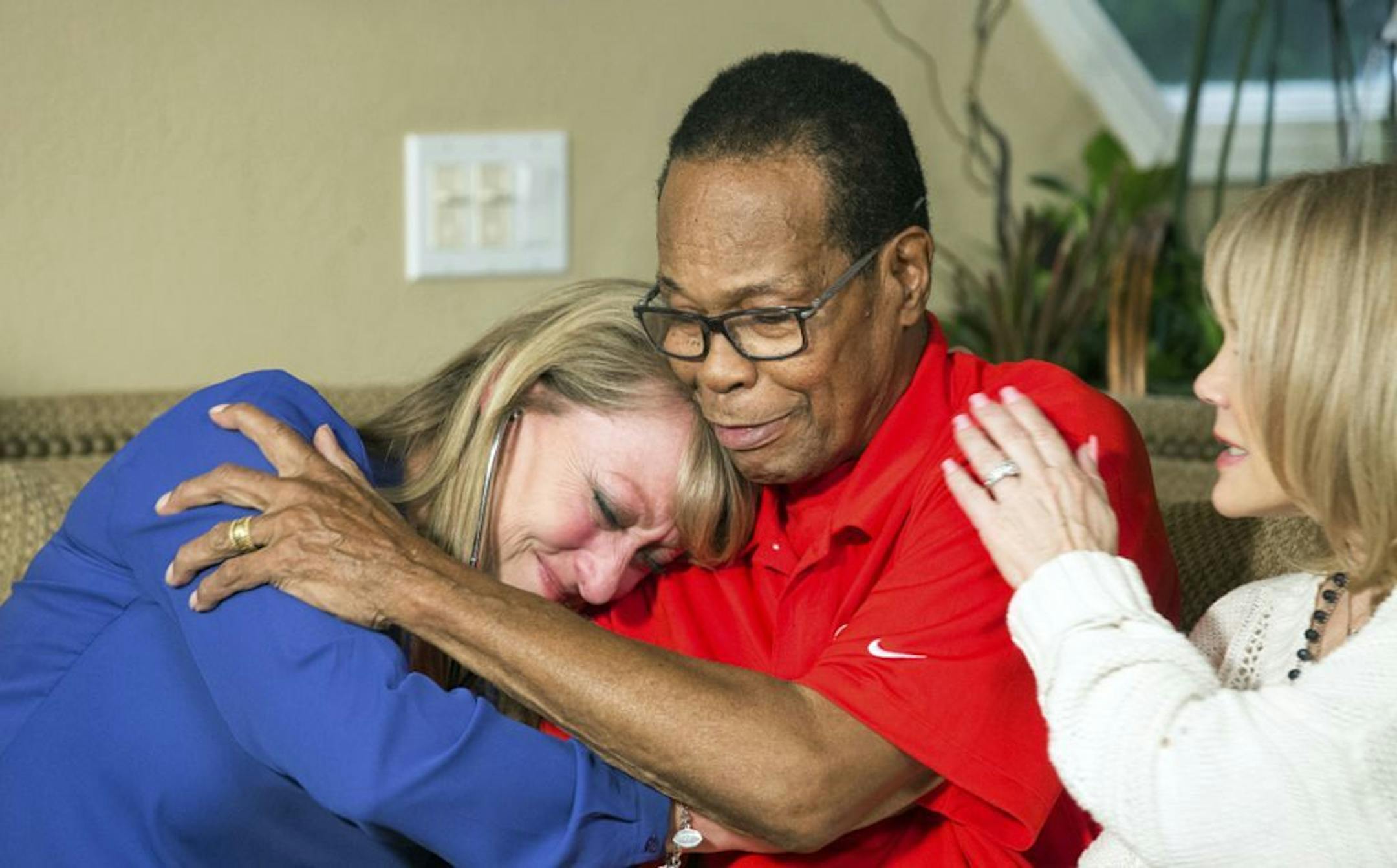 In this March 2, 2017, photo provided by the American Heart Association, Mary Reuland, left, mother of Konrad Reuland, embraces former baseball player Rod Carew as Carew's wife, Rhonda, watches at the Reuland home in San Juan Capistrano, Calif. Konrad Reuland was a former NFL football player who died of a brain aneurism at the age of 29 in December 2016. Reuland's heart and a kidney were anonymously transplanted into Carew. Mutual friends connected Reuland's death with news of Carew's transplant