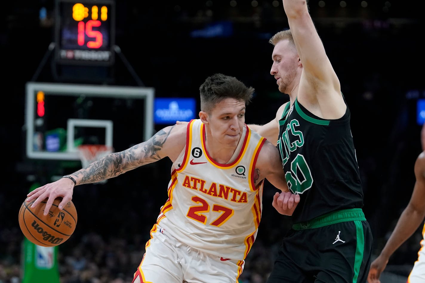 Atlanta Hawks guard Vit Krejci (27) drives toward the basket as Boston Celtics forward Sam Hauser (30) defends in the second half of an NBA basketball game, Sunday, April, 9, 2023, in Boston. (AP Photo/Steven Senne)