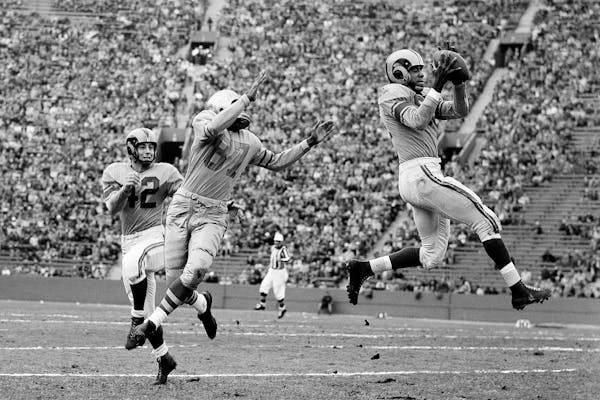 FILE - In this Dec. 7, 1952, file photo, Los Angeles Rams' Dick "Night Train" Lane leaps to intercept a Green Bay Packers pass intended for Packers' e