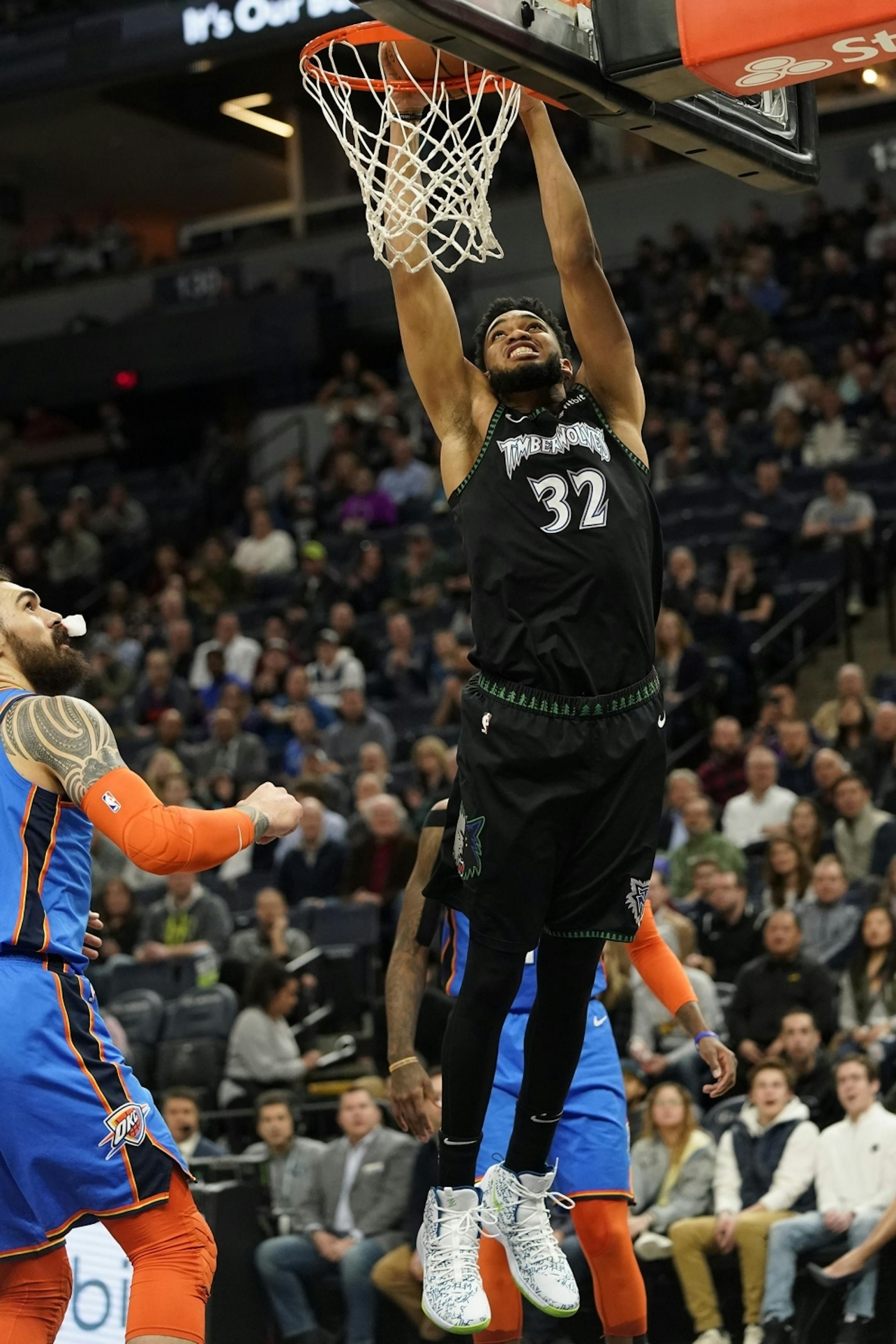 Minnesota Timberwolves center Karl-Anthony Towns (32) dunks the ball during the first half.