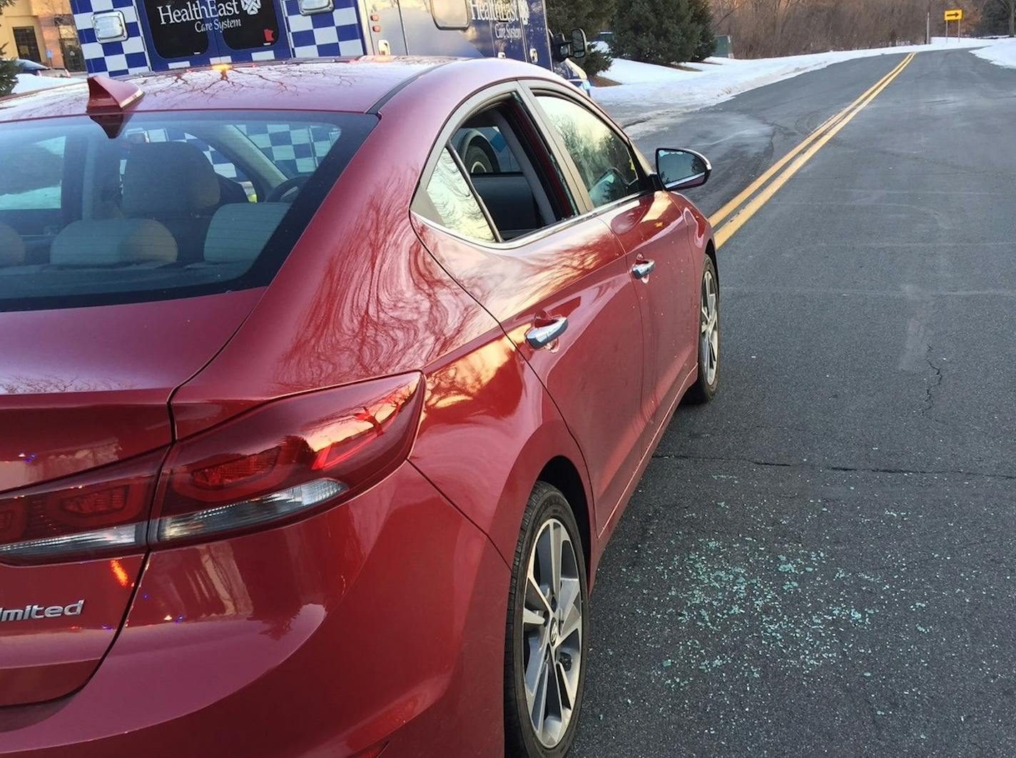 A stranger busted out the window of the ailing woman's car, allowing her to be given aid before first responders arrived.