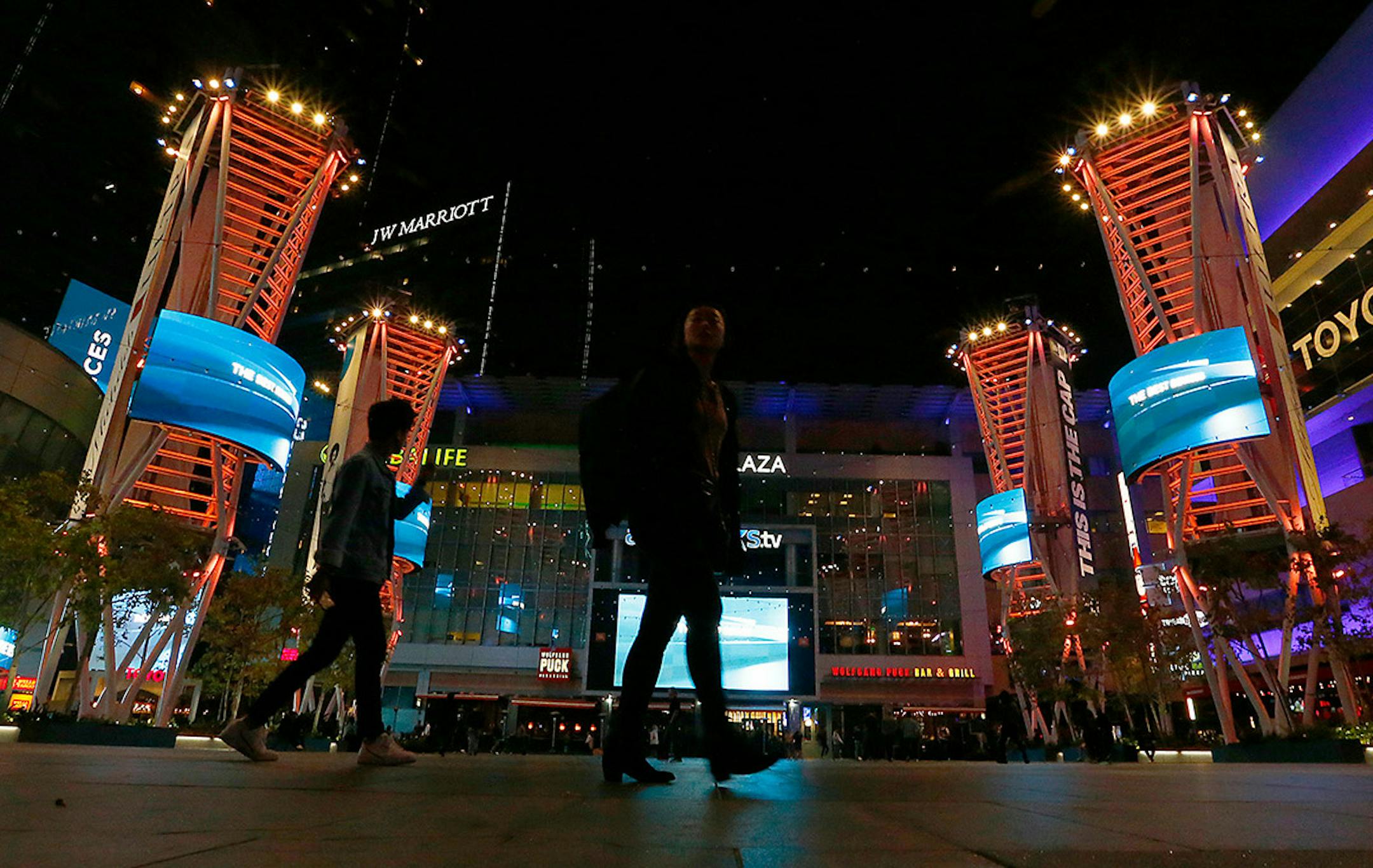 A couple stroll through LA Live in downtown Los Angeles on Nov. 7, 2019. (Luis Sinco/Los Angeles Times) ORG XMIT: 1494207