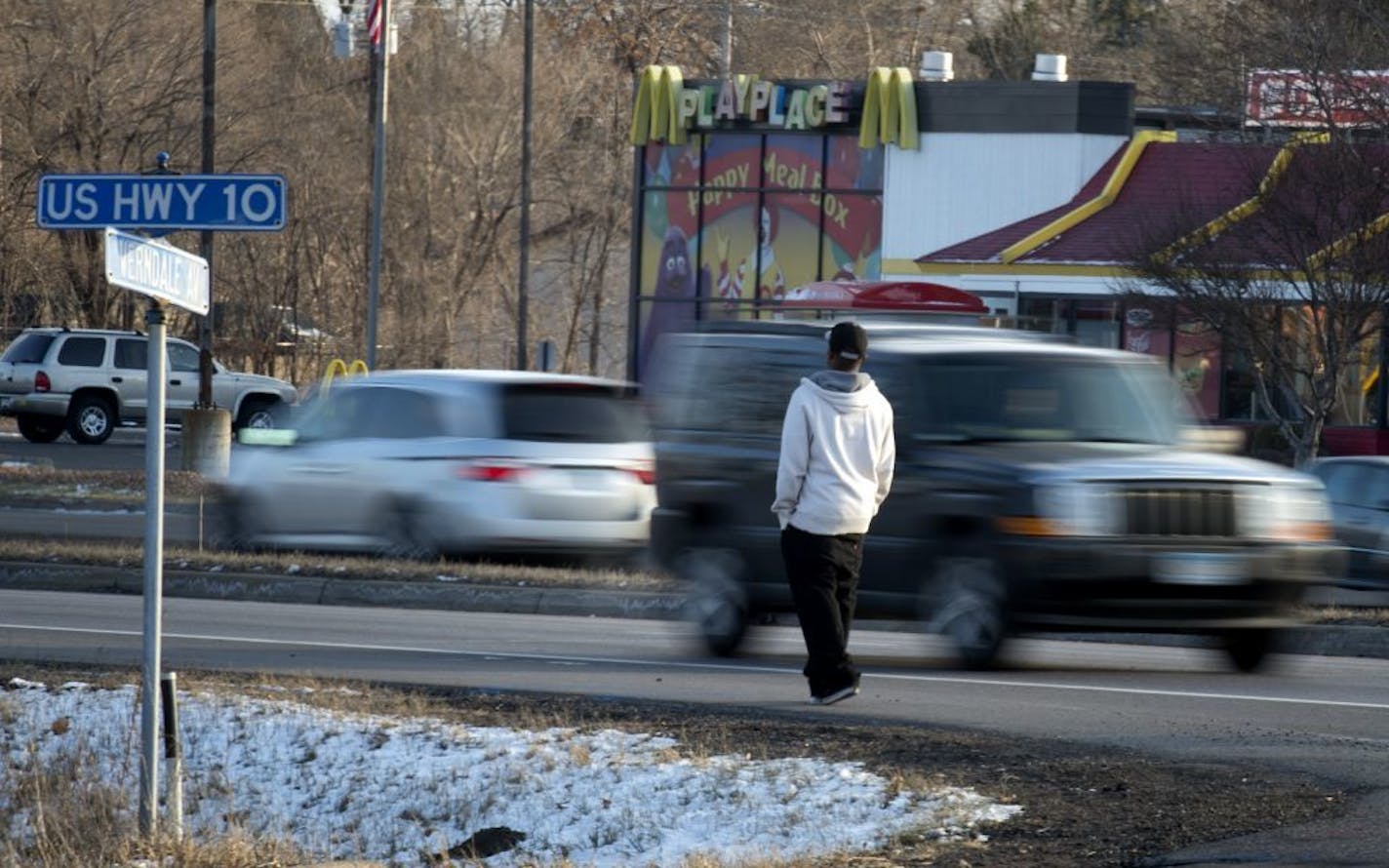 A pedestrian waited for an opportunity to cross busy State Highway 10 in Anoka at Verndale Ave near the location where Hannah Craft, 16, was killed Monday night while crossing the same road on her way to work at the McDonalds across the street. Tuesday, November 27, 2012.