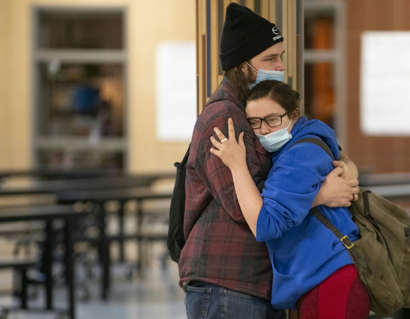 Gavin Lawrence embraced his girlfriend, Chace Johnson, in between classes at South Ridge School. It is one of only a few school buildings in Minnesota where students are still attending for in-person instruction, five days a week.