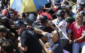 White nationalist protesters clash with counterprotesters at the entrance to Lee Park in Charlottesville, Va., on Aug. 12, 2017. Gov. Terry McAuliffe 