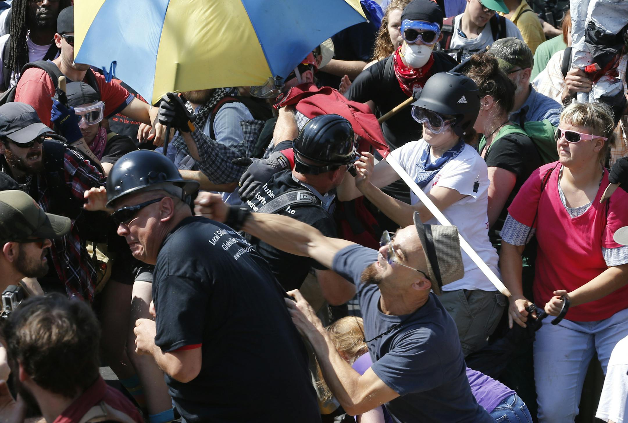 White nationalist protesters clash with counterprotesters at the entrance to Lee Park in Charlottesville, Va., on Aug. 12, 2017. Gov. Terry McAuliffe declared a state of emergency and police in riot gear ordered people to disperse after the chaotic violent clashes.