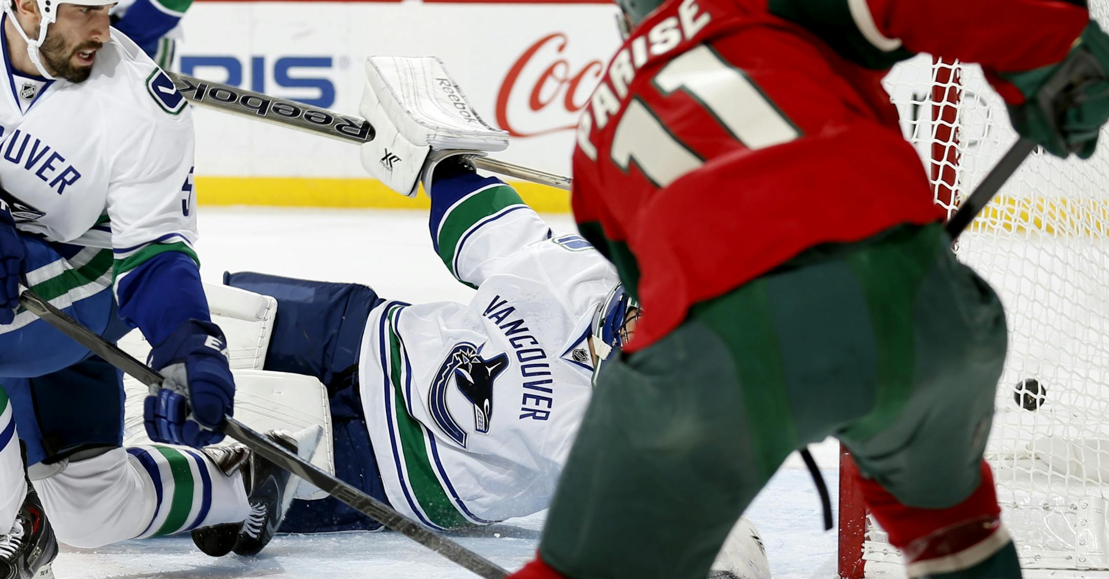 Zach Parise (11) shot the puck past Vancouver goalie Roberto Luongo (1) for a goal.