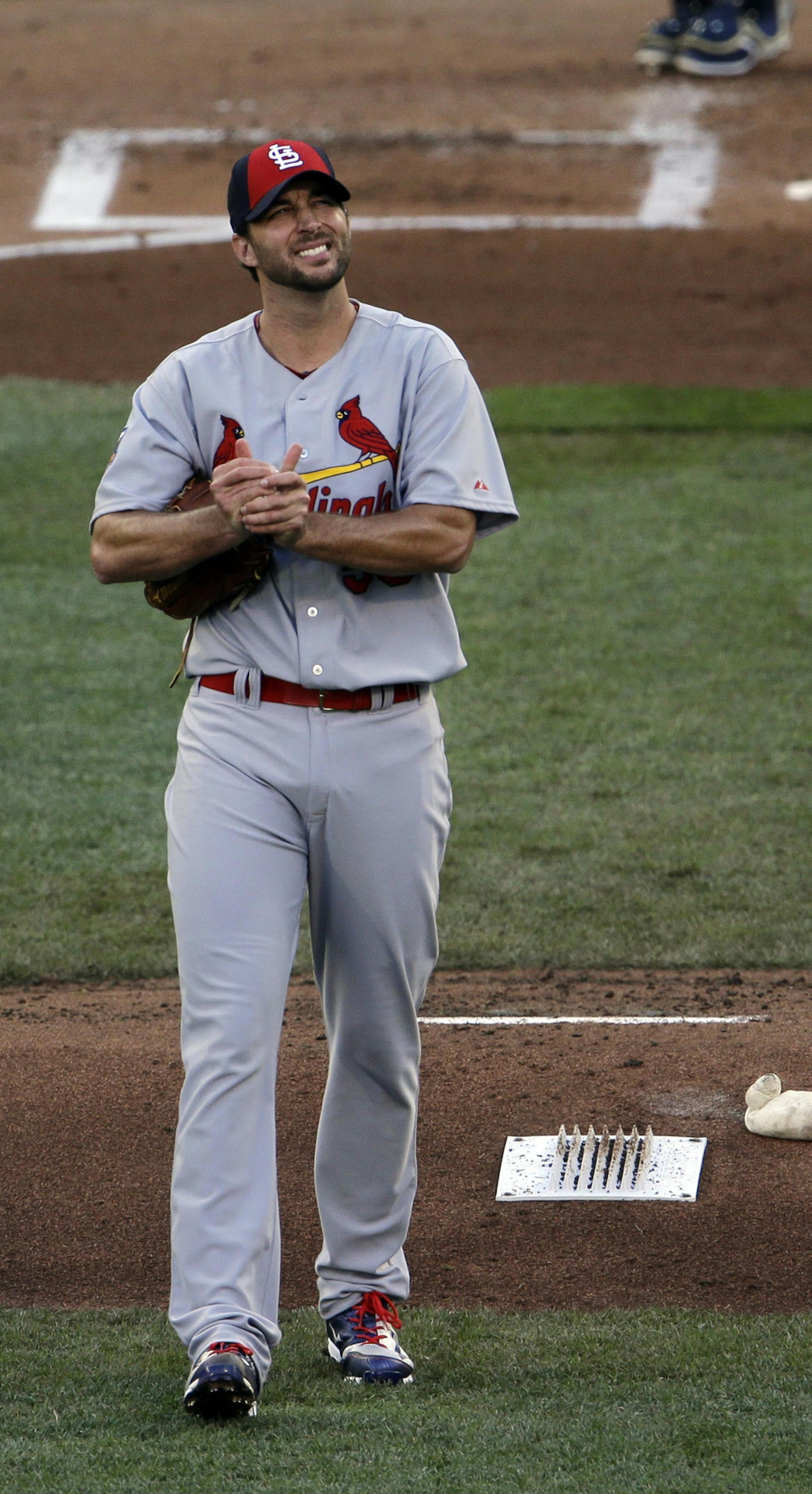 National League starting pitcher Adam Wainwright returns to the mound after giving up a home run to Miguel Cabrera, of the Detroit Tigers during the first inning of the MLB All-Star baseball game, Tuesday, July 15, 2014, in Minneapolis. (AP Photo/Paul Sancya)