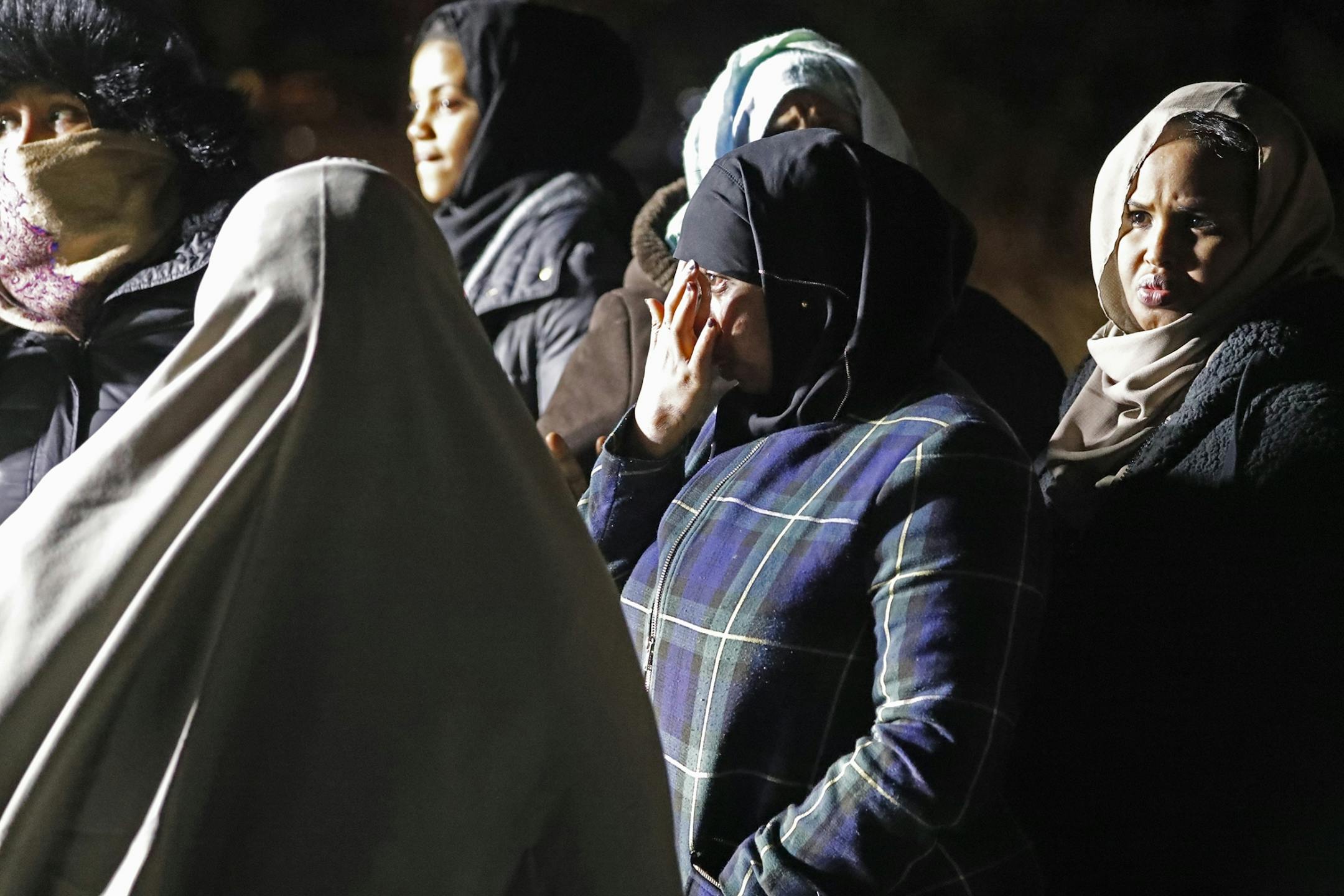 Members of the Somali community grieve at the scene.