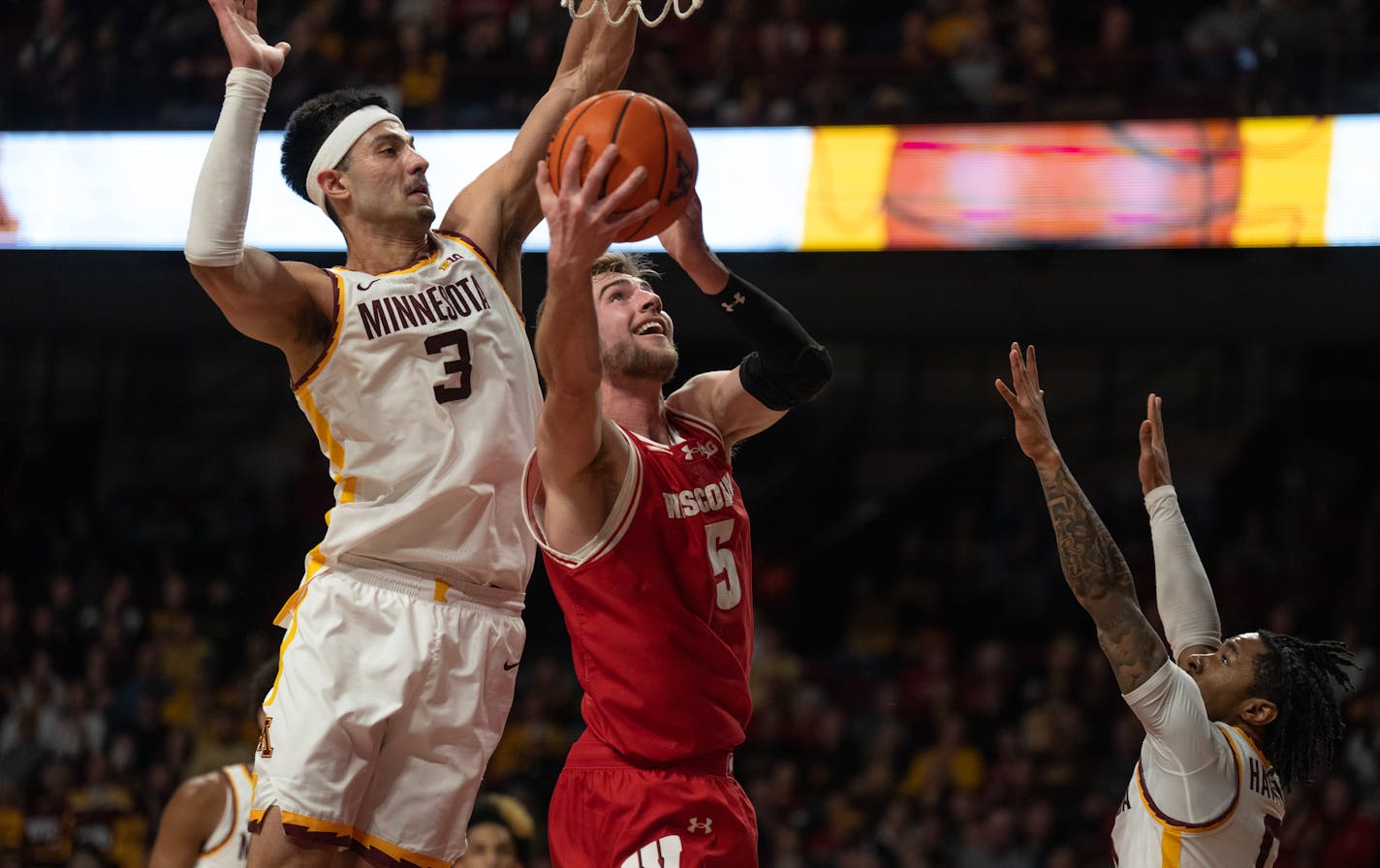 Wisconsin Badgers forward Tyler Wahl (5) scored over Minnesota Golden Gophers forward Dawson Garcia (3) in the second half Tuesday January 22, 2024 in,Minneapolis.