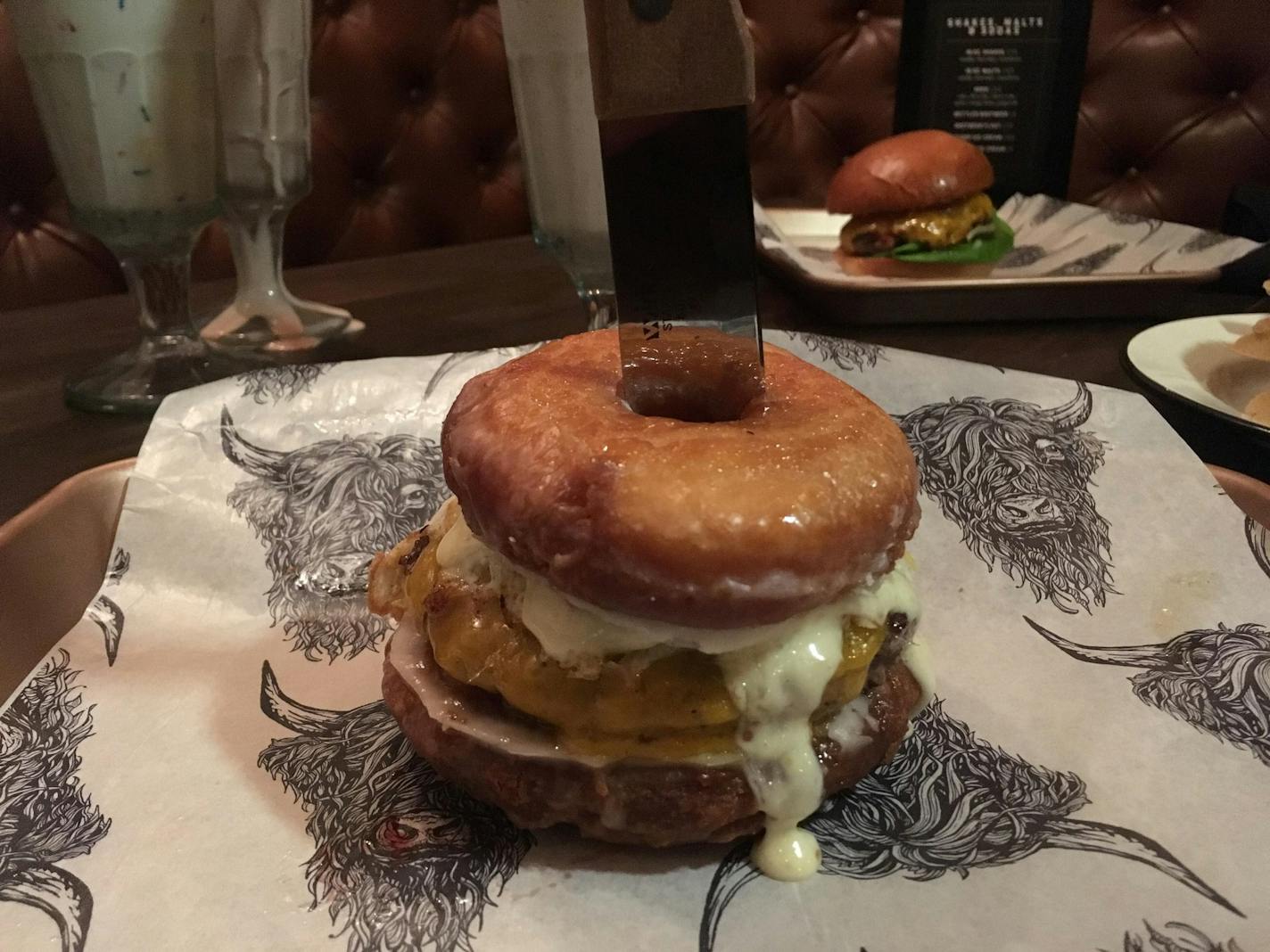 A burger wtih doughnuts for a bun at Copper Cow in Minnetonka