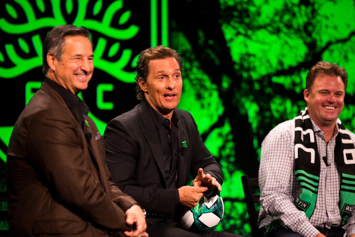 Matthew McConaughey, center, jokes as Dell President and Chief Commercial Officer Marius Haas, left, and Austin FC CEO Anthony Precourt laugh during an Austin FC investor ceremony in August.