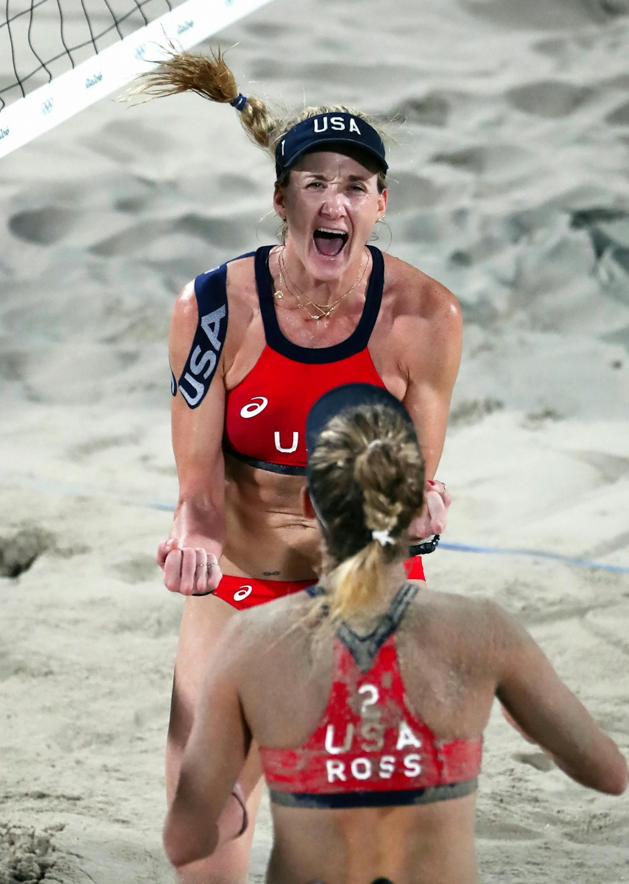 USA's Kerri Walsh Jennings (top) and April Ross celebrate their victory in the bronze medal match against Larissa Franca Maestrini and Talita Rocha from Brazil.