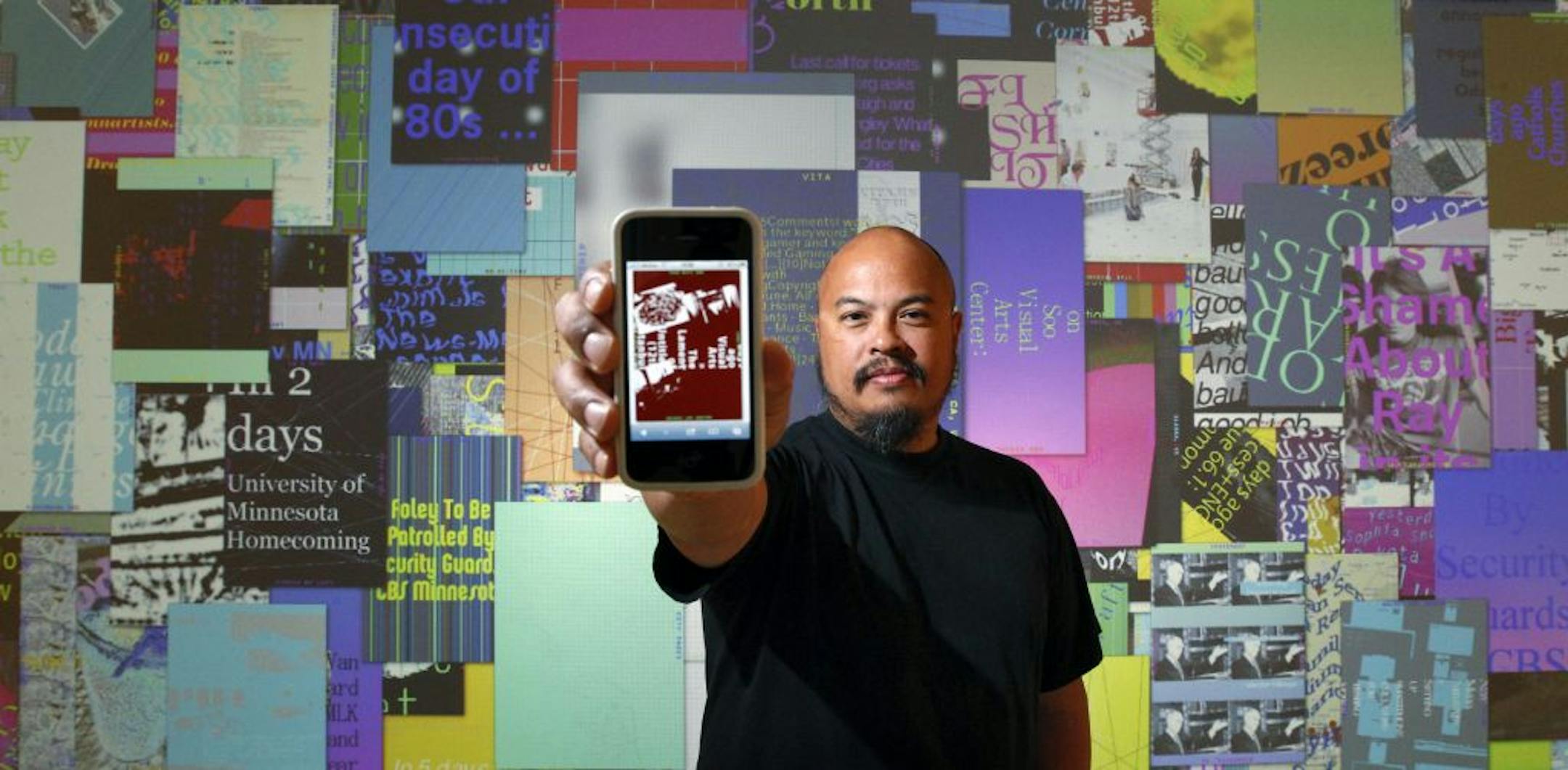 Thomas Castro, artist with the LUST design firm, in front of his company's installation at "Graphic Design" Now in Production"