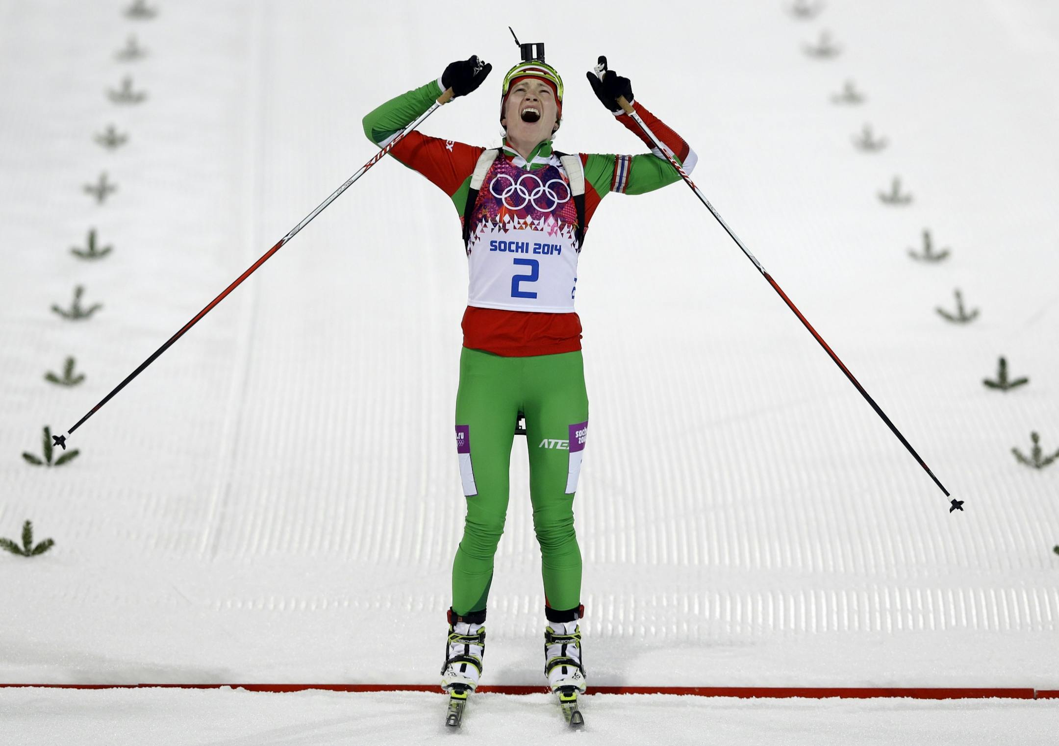 Belarus' Darya Domracheva celebrates winning the gold medal in the women's biathlon 12.5k mass-start, at the 2014 Winter Olympics, Monday, Feb. 17, 2014, in Krasnaya Polyana, Russia.