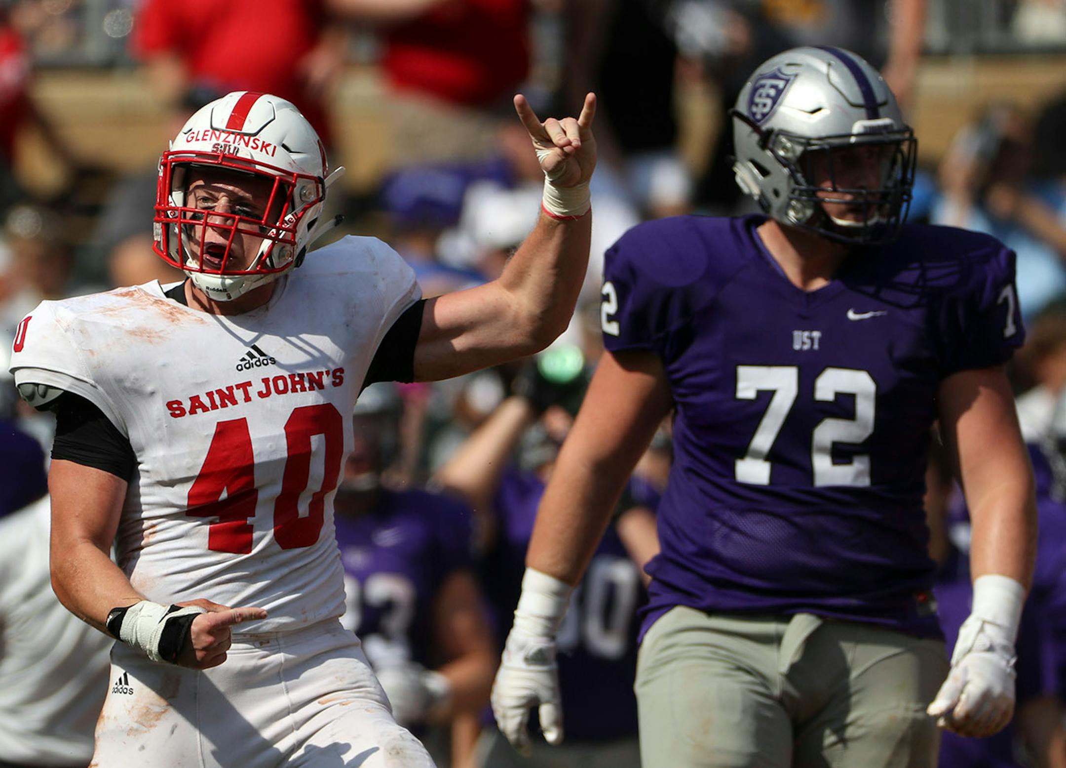 St. John's University defensive lineman Drew Glenzinski (40) celebrated after sacking University of St. Thomas quarterback Jacques Perra (16) in the first half.