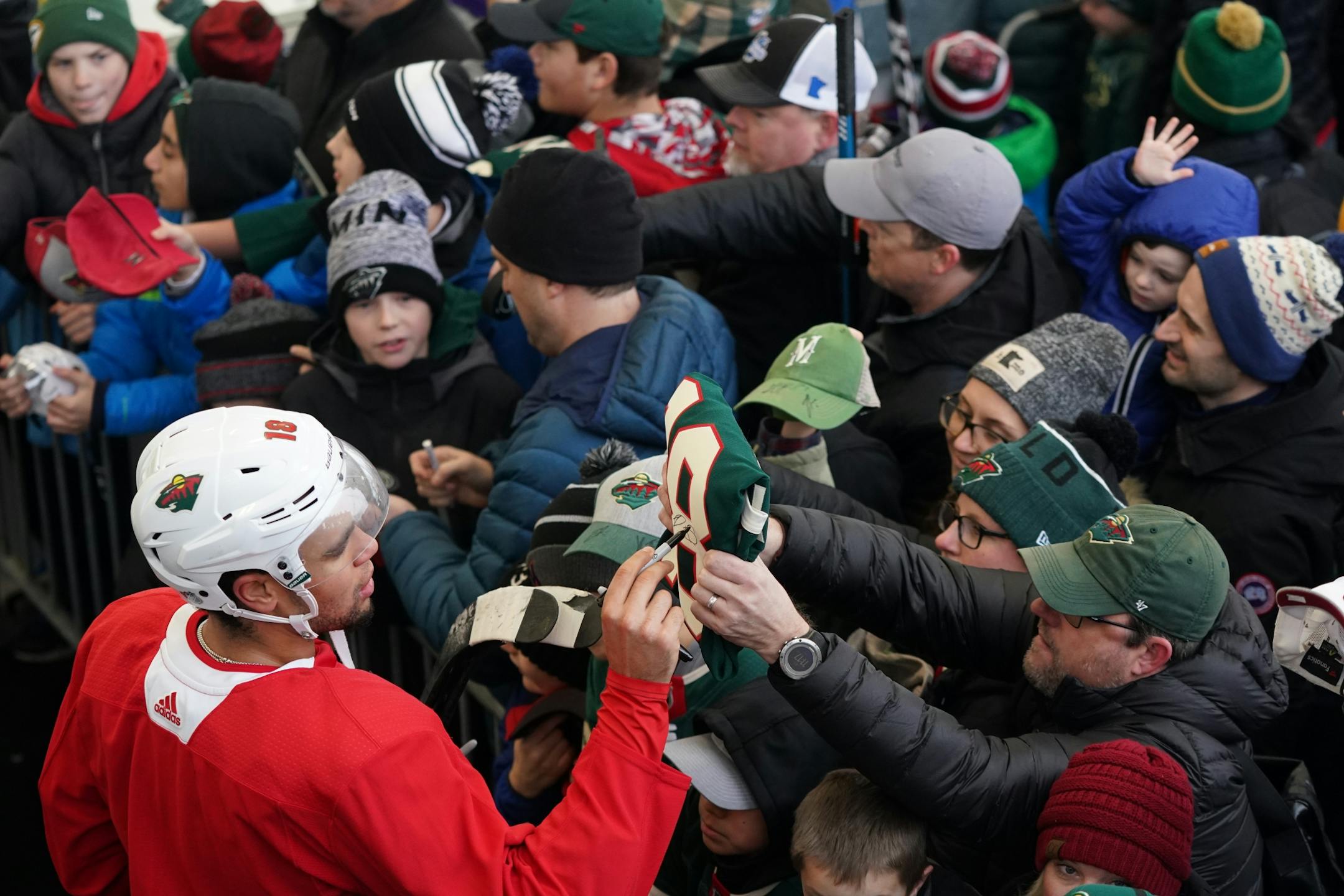 Minnesota Wild left wing Jordan Greenway (18) signed autographs following the Wild's outdoor practice Thursday.
