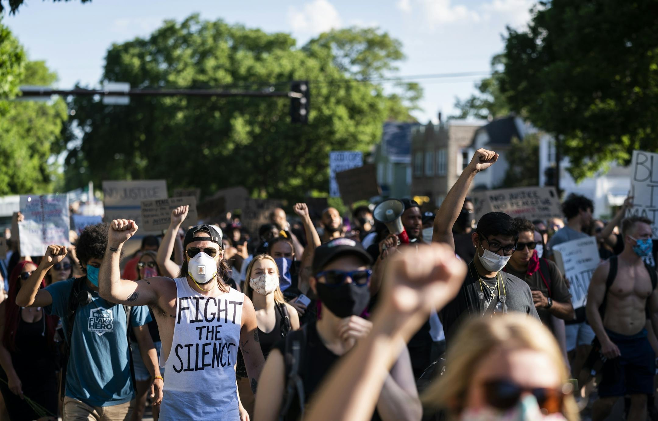 Protesters raised their fists during a march that was headed back downtown after marching from U.S. Bank Stadium to Cup Foods.