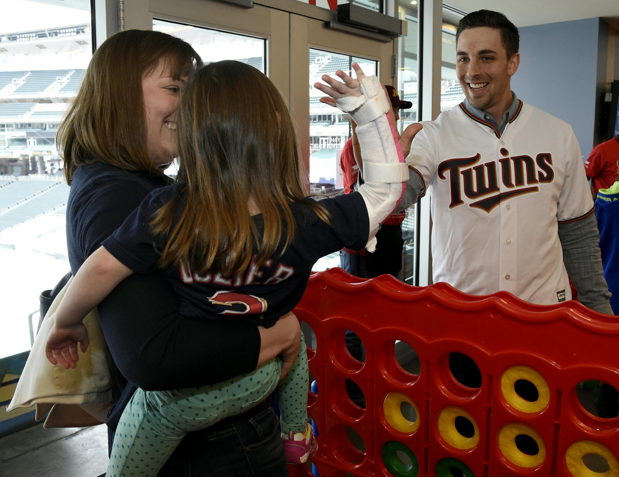 Minnesota Twins' Jason Castro high fives a fan after playing a game during the baseball team's fan fest Saturday, Jan. 28, 2017 in Minneapolis. (AP Photo/Hannah Foslien)
