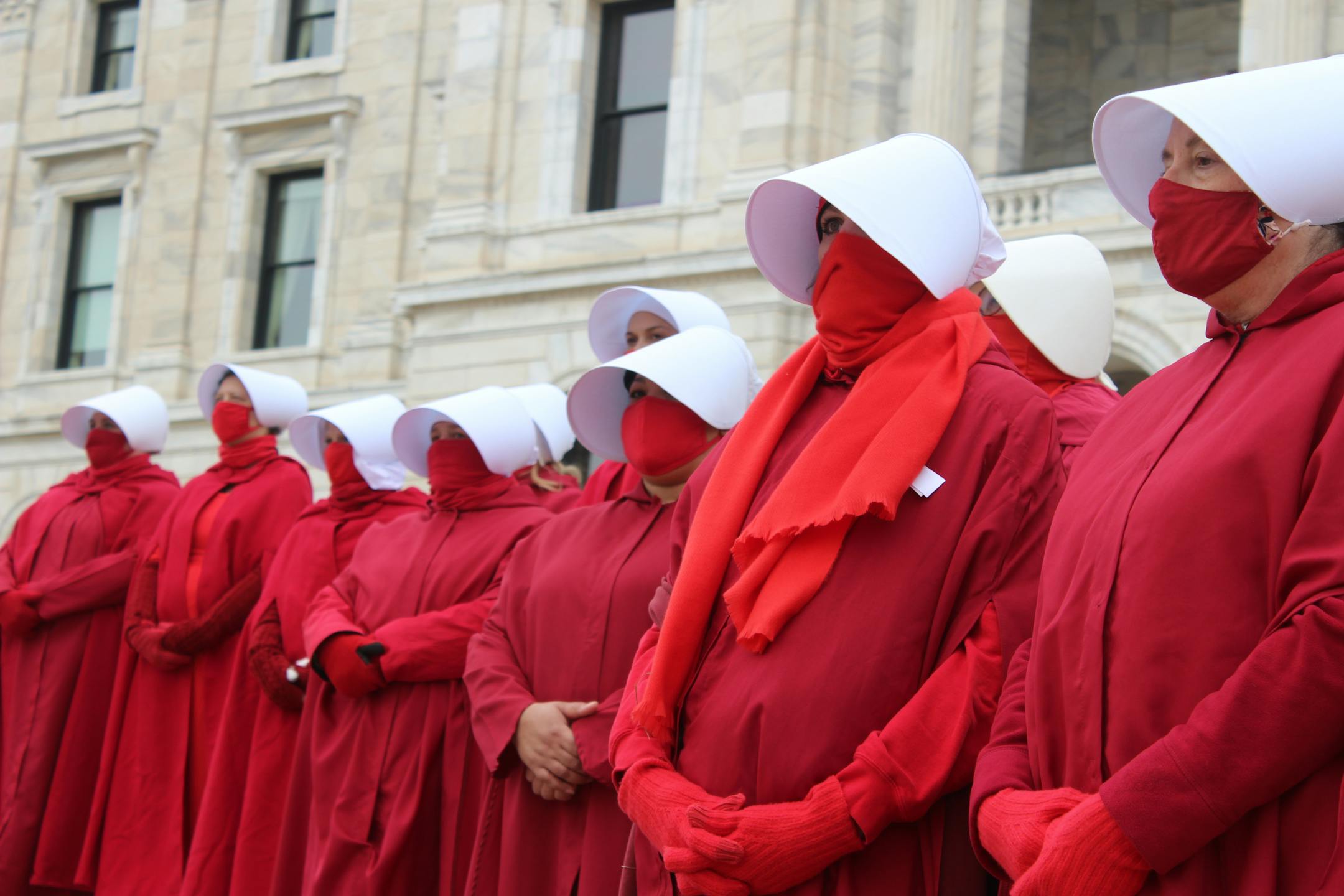 Members of the Handmaids of Minnesota stand on the capitol steps Nov. 8 to protest for a National Day of Action.