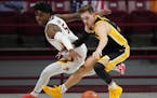 Minnesota guard Marcus Carr (5) and Iowa guard Jordan Bohannon (3) raced for a loose ball in the second half. ] ANTHONY SOUFFLE • anthony.souffle@st