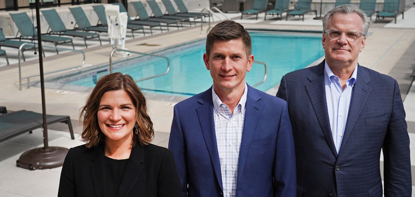 Doran Companies CEO Anne Behrendt, CFO Ryan Johnson, and founder Kelly Doran in May on the pool deck of the Doran-developed-and-managed Mill and Main luxury apartment building on the Mississippi River. Photo: Shari L. Gross &#x2022; shari.gross@startribune.com