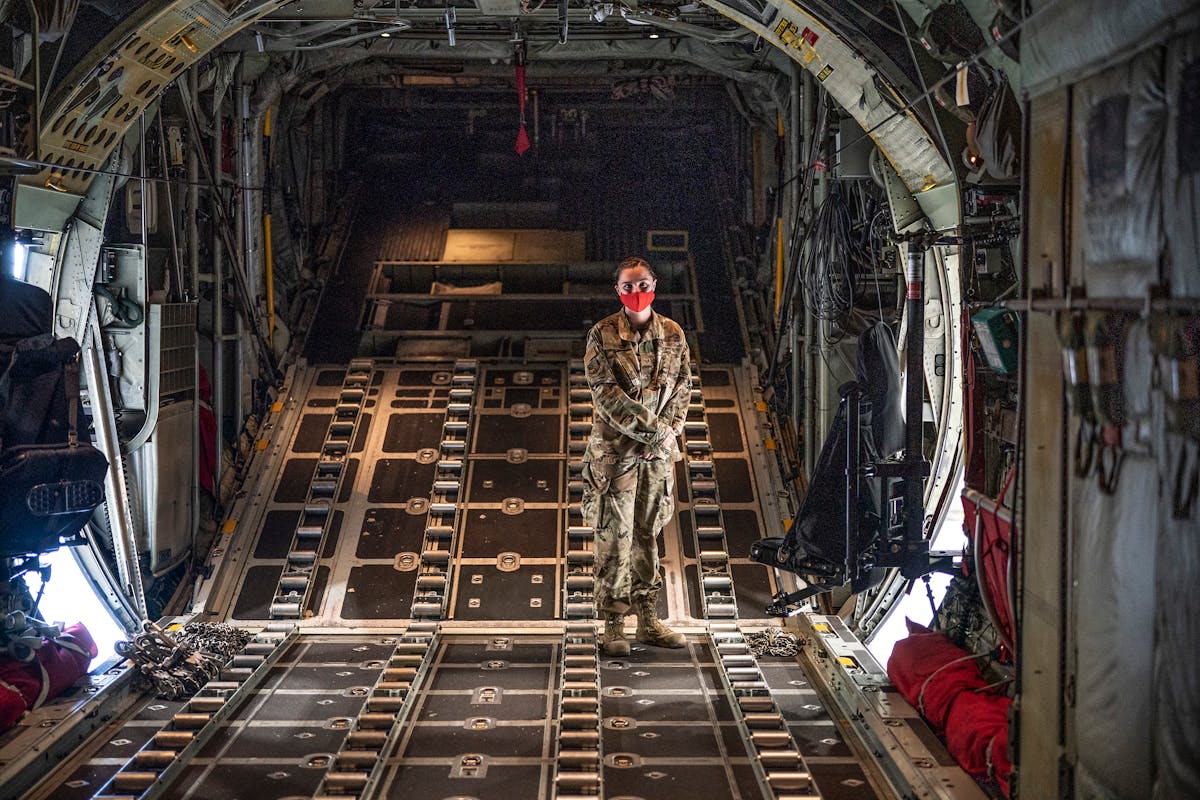 Emily Berg, a young airman with the 133rd Airlift Wing with a C-130 cargo airplane. Her dad flew on Gopher 06, the C-130 that flew over the Pentagon a