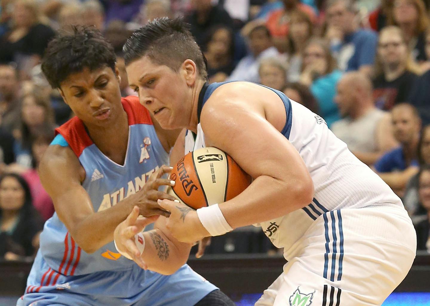 Atlanta's Angel McCoughtry and Lynx Janel McCarville fought for possession during the first half in July 2014.