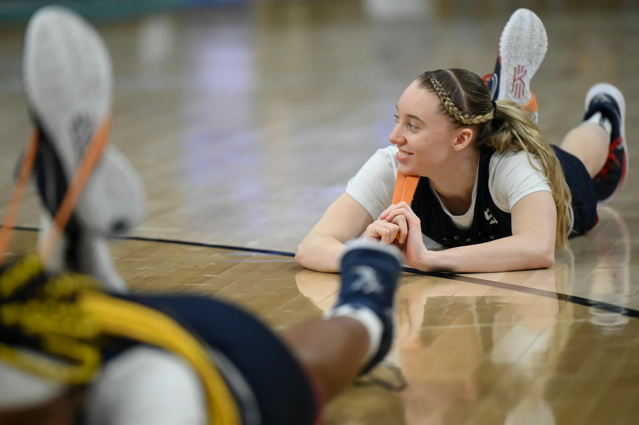 UConn guard Paige Bueckers (5) smiles as she stretches during a Final Four open practice held Saturday, April 2, 2022 at Target Center in Minneapolis, Minn.