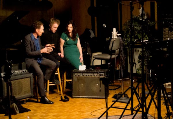 Phil Harder, left, talks to Low’s Alan Sparhawk and Mimi Parker during the making of a video seen in the new movie “Cue the Strings: a Film About 