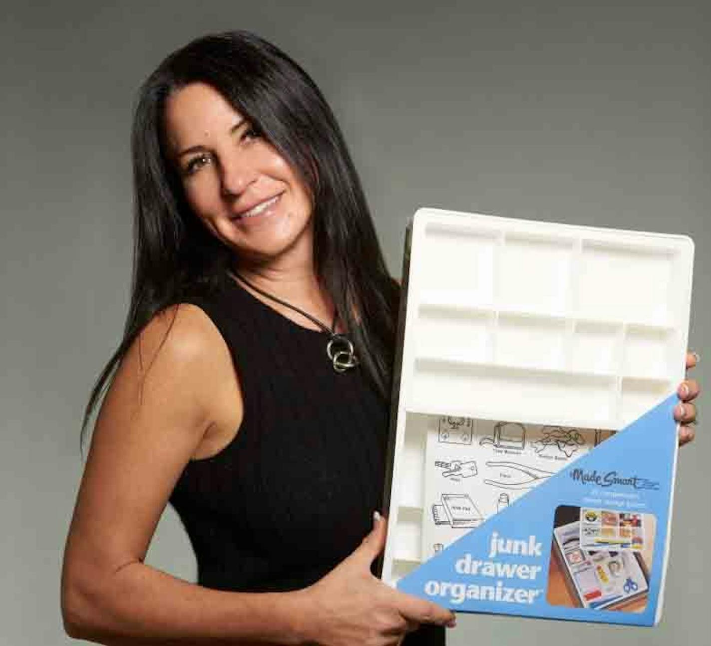 Devee McNally, CEO and founder of MadeSmart, the St. Paul-based designer of home-organizer tools, with the original "junk-drawer" organizer that she designed in 1990.