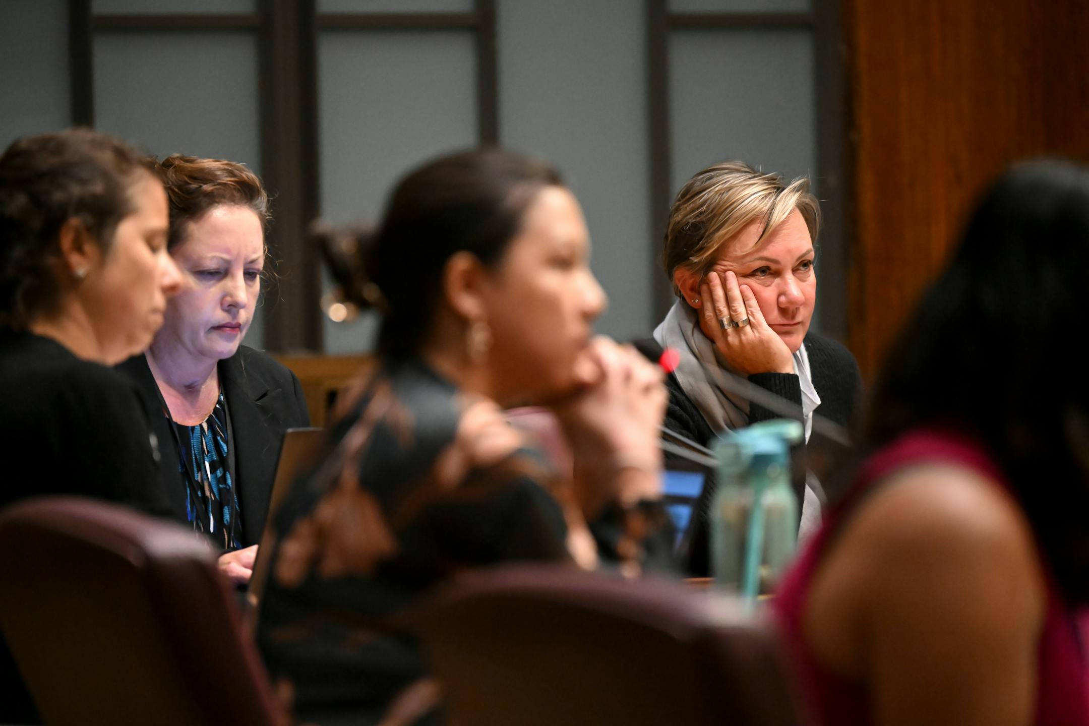 Council President Amy Brendmoen, right, listens to public comment during a city council meeting.