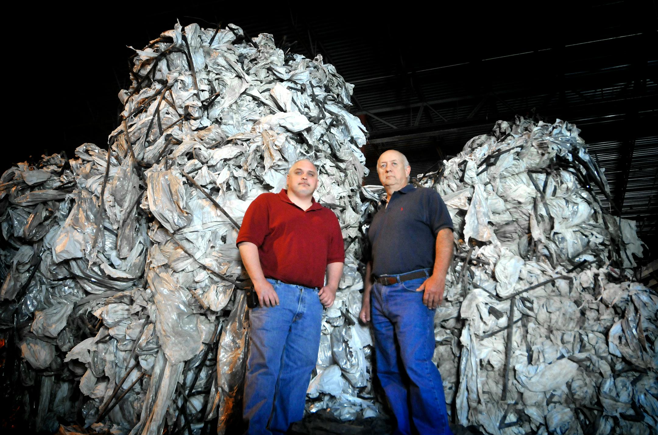 John Schmitz and Karl Bohn have stacks upon stacks of hard-to-recycle plastics ready to be turned into pellets that can be sold to manufacturers of plastic lumber, pallets and drain tile. AGSI Recycling in Savage will receive machinery next month that will chew up old silage bags, crop and hay covers and boat wraps.