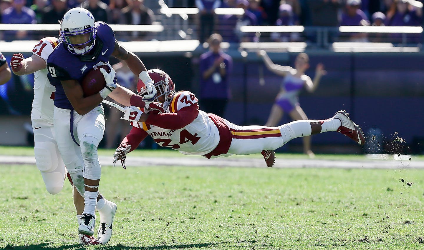 TCU wide receiver Josh Doctson (9) breaks a tackle by Iowa State defensive back Nigel Tribune (34) during the first half of an NCAA college football game at Amon G. Carter Stadium, Saturday, Dec. 6, 2014, in Fort Worth, Texas. (AP Photo/Brandon Wade)