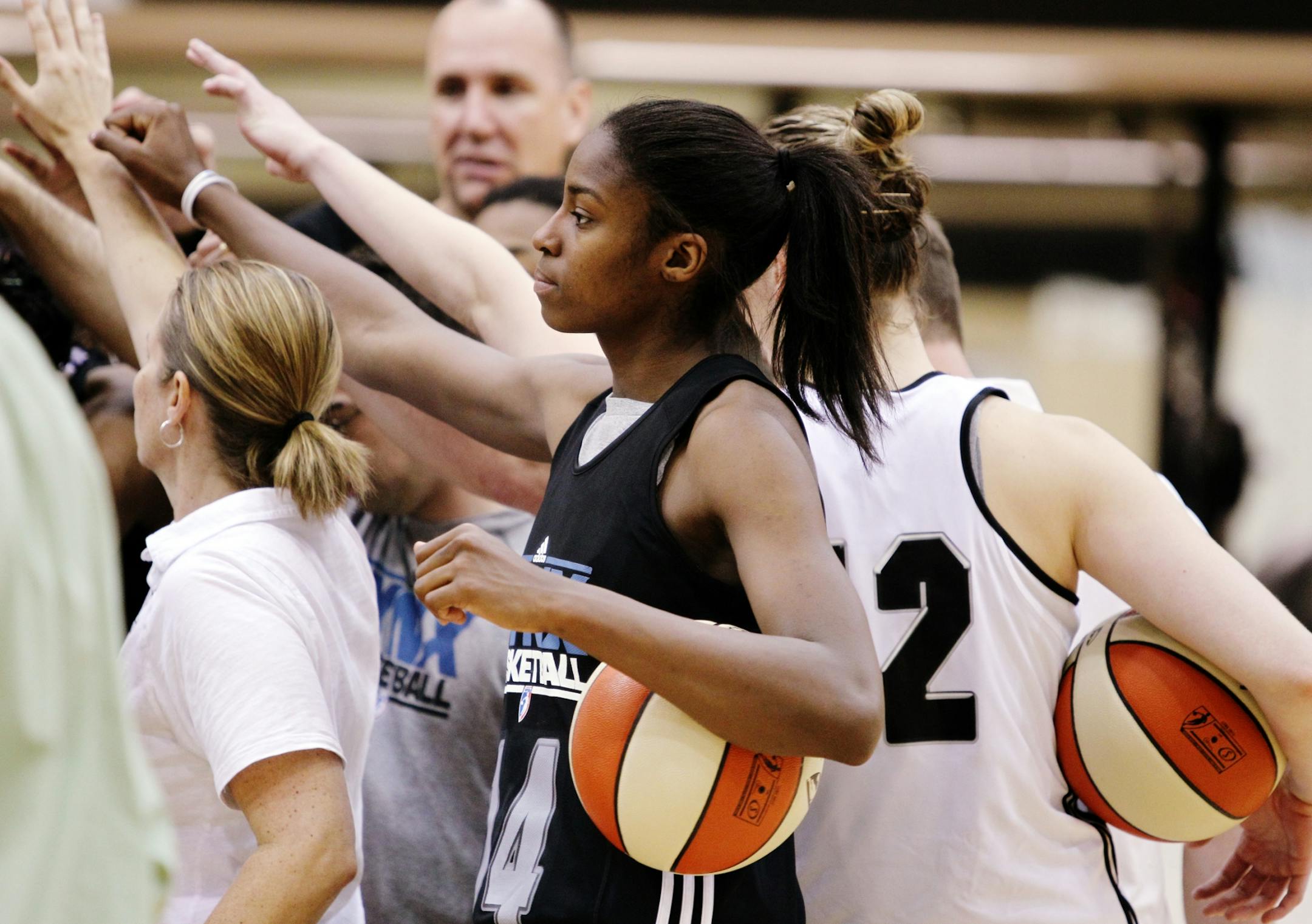 Rookie Devereaux Peters huddled with Lynx players Sunday during a break in drills on the opening day oft training camp. Peters said of her offseason conditioning work: "No matter what they throw at me, as long as I am conditioned, I should be able to handle it."