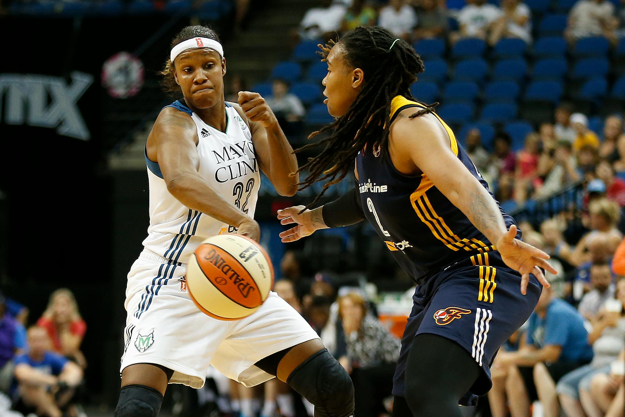 Minnesota Lynx forward Rebekkah Brunson (32) tries to pass the ball around Indiana Fever forward Erlanka Larkins during the first half of a WNBA basketball game, Friday, Sept. 4, 2015, in Minneapolis. (AP Photo/Stacy Bengs)