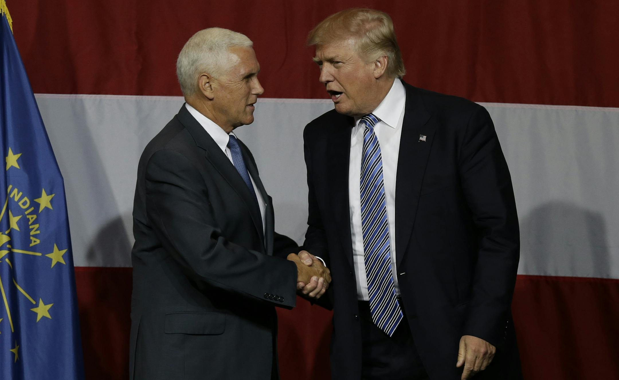 Indiana Gov. Mike Pence joins Republican presidential candidate Donald Trump at a rally in Westfield, Ind., Tuesday, July 12, 2016. (AP Photo/Michael Conroy) ORG XMIT: MIN2016071511111819