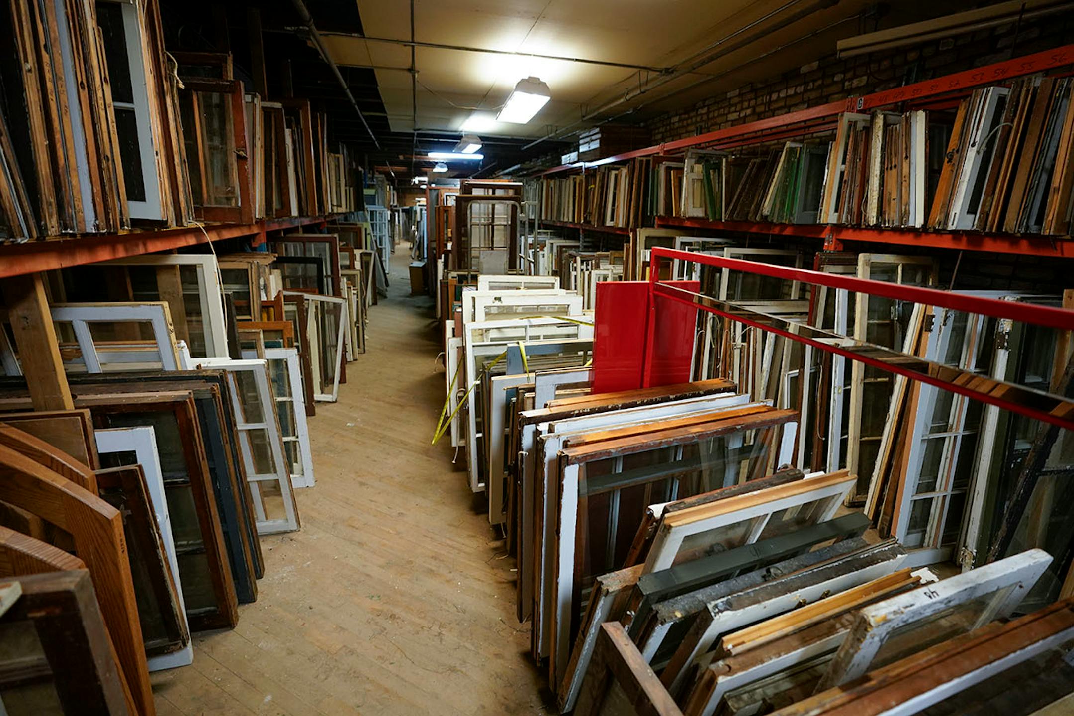 Windows line the shelves of the 2nd floor warehouse.