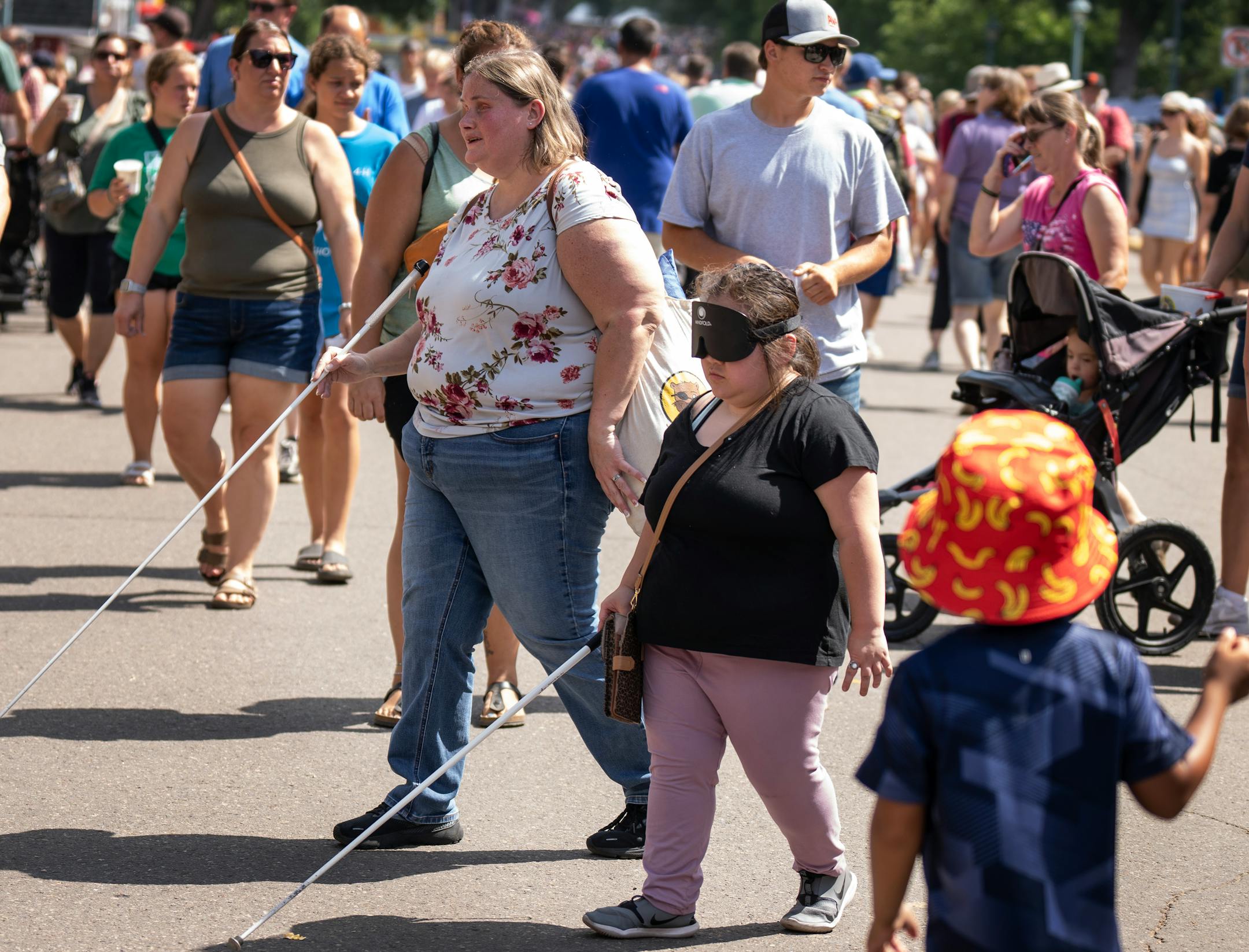 Jamie Richey left, interim executive director and Isabellah Khang 21, both are blind and spent the day with other students from the school.
