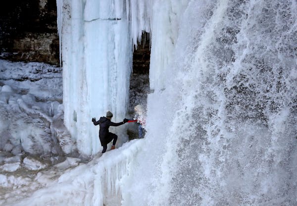 Thrill seekers risk limb if not life to get an up and close look at the partially frozen Minnehaha Falls Tuesday, Jan. 3, 2016, in Minneapolis, MN.](D
