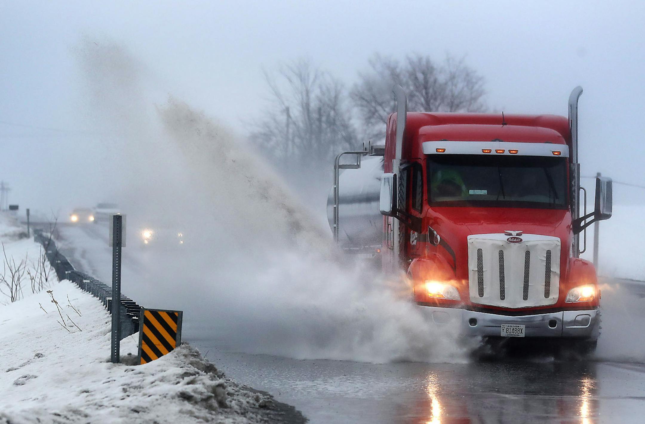 The first precipitation to fall came in the form of rain as a semi truck plowed through a puddle on Highway 212, southwest of Eden Prairie Saturday, March 9, 2019, in Eden Prairie, MN.] DAVID JOLES •david.joles@startribune.com Big spring snowstorm