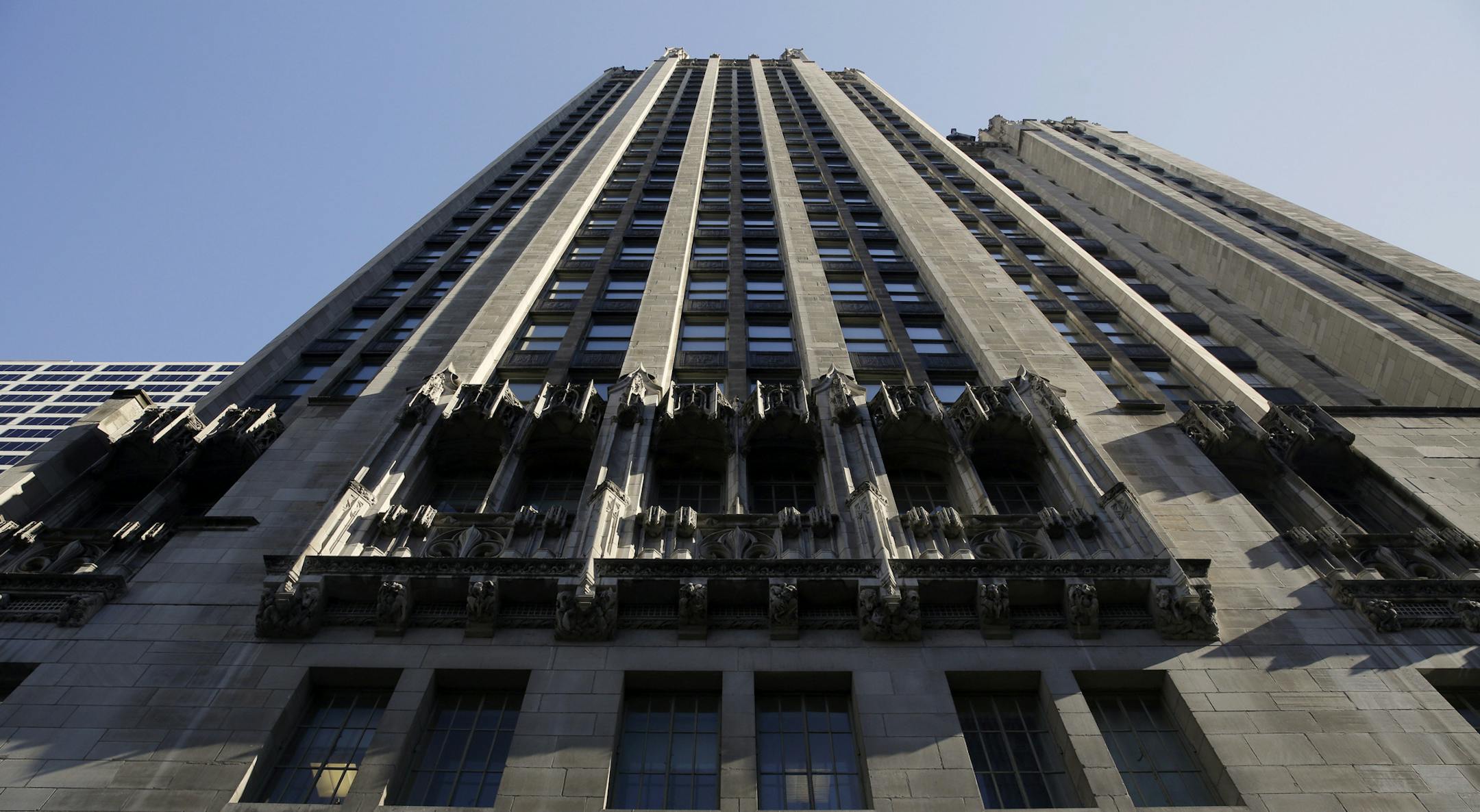 The WGN Radio sign appears on the side of Tribune Tower, Monday, May 1, 2017, in downtown Chicago. TV station operator Tribune Media is at the center of a possible bidding war, following reports that Fox News owner 21st Century Fox and investment firm Blackstone may make a joint takeover bid for the company. Tribune owns or operates 42 local TV stations across the nation, including WPIX in New York, KTLA in Los Angeles and WGN in Chicago. (AP Photo/Kiichiro Sato)