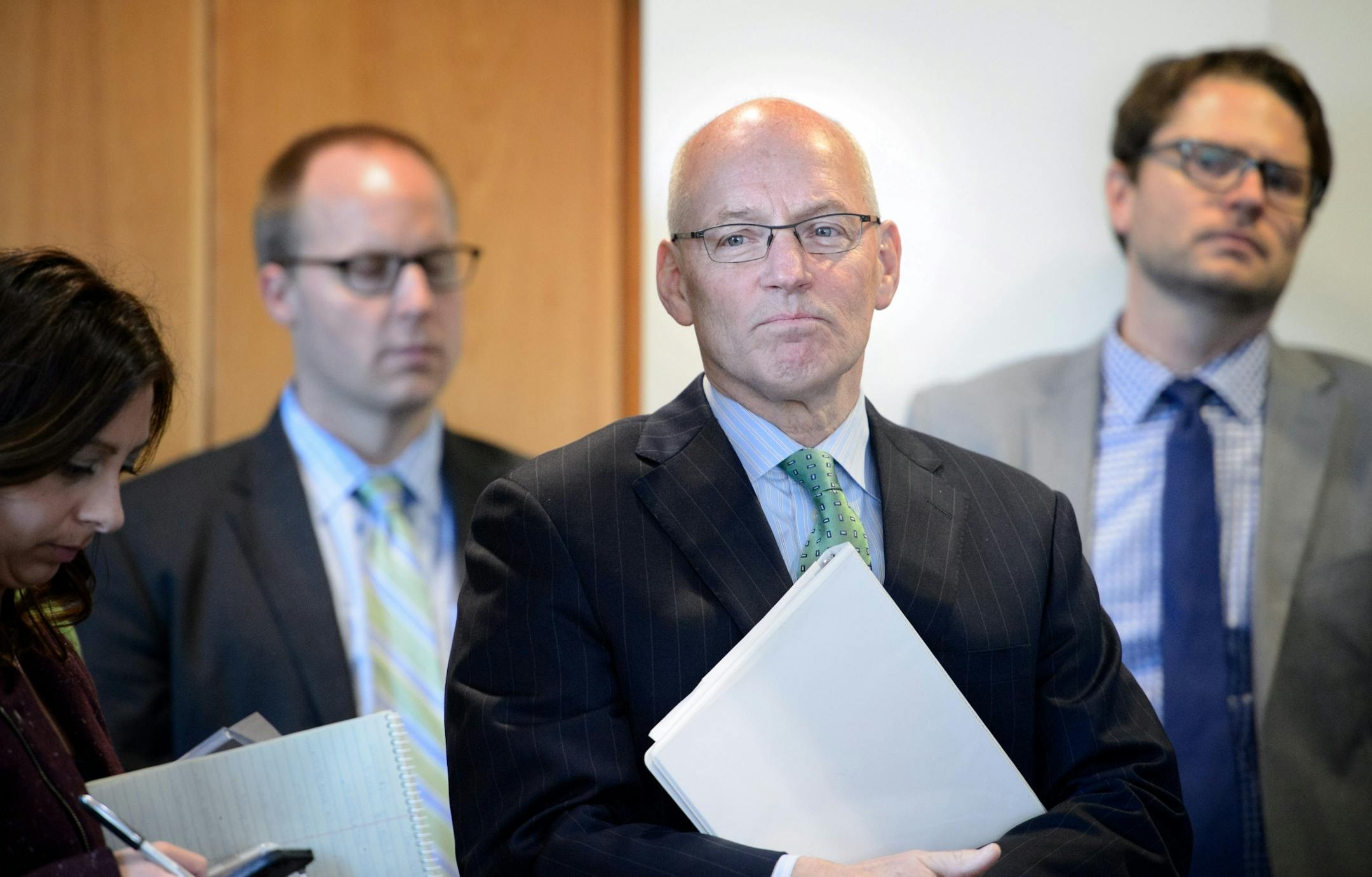 Minnesota Management and Budget Commissioner Myron Frans listened as Governor Dayton praised his work on the budget forecast.