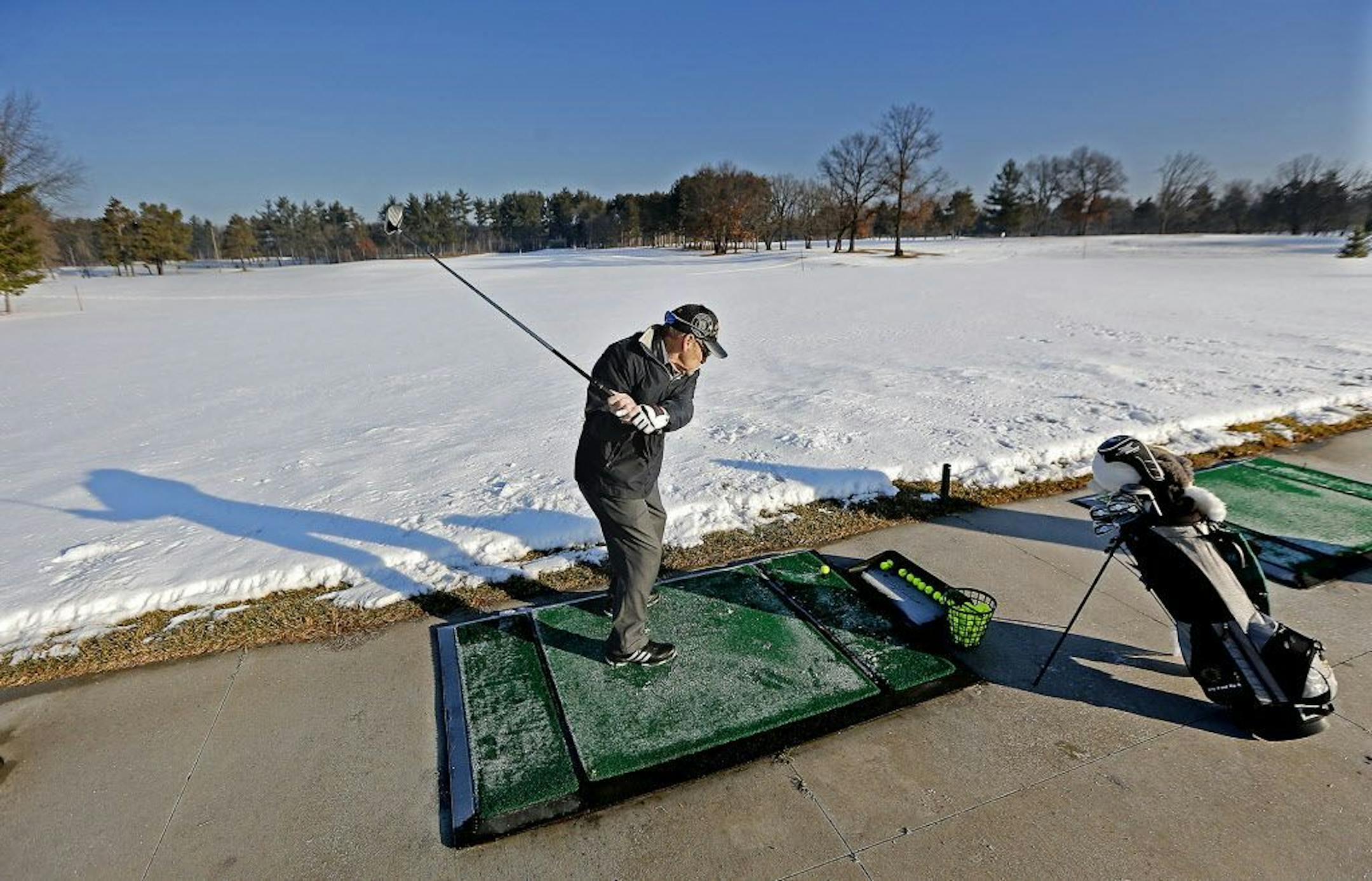 Vietnam Veteran Jim Murray of Coon Rapids, took advantage of the warm weather to practice his swing at the Bunker Hills Golf Club's driving range, Thursday, January 19, 2017 in Coon Rapids, MN.