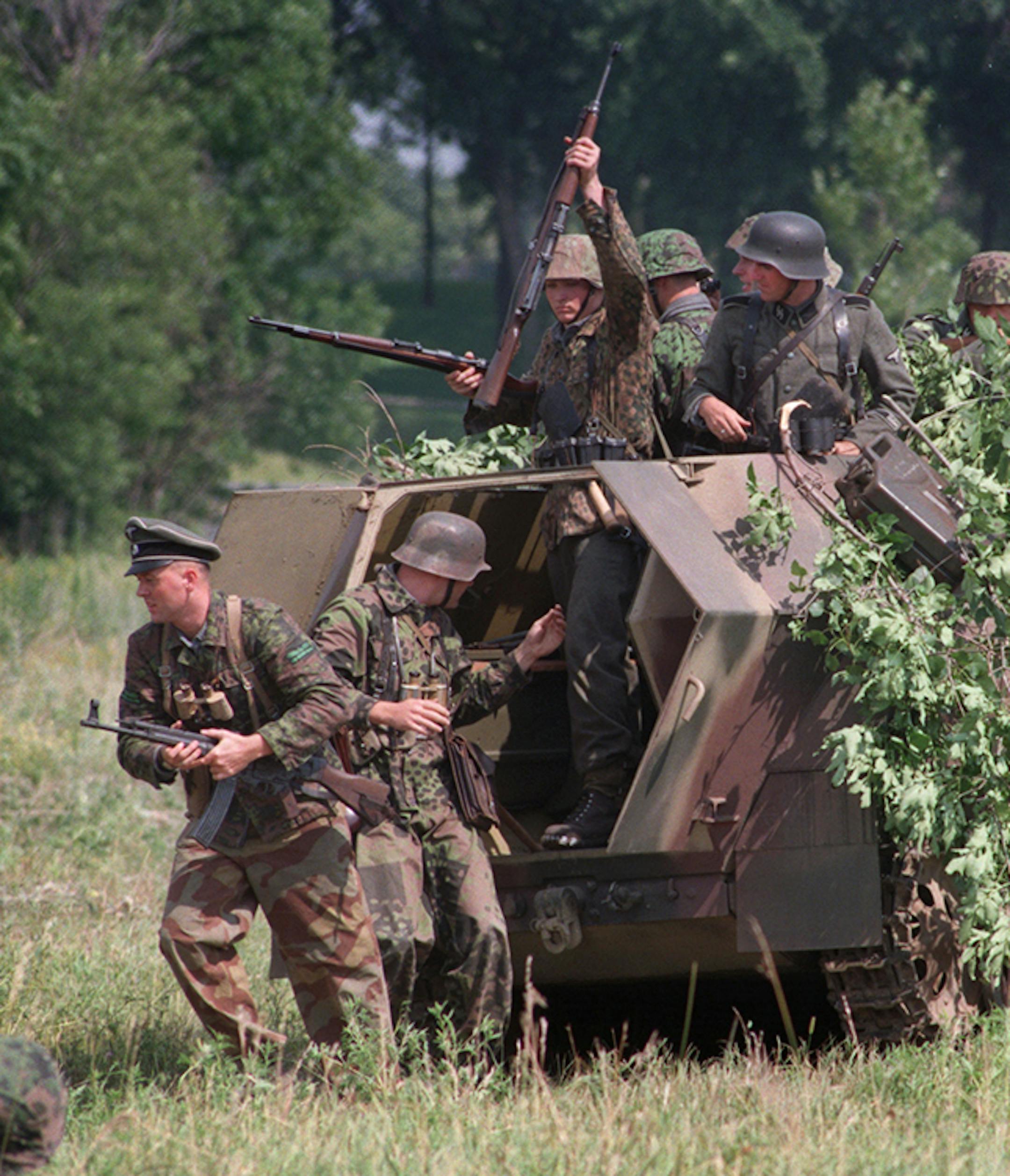 A group called the Historical Reenactment Society reenacted an ambush for onlookers attending the Minnesota Military Expo held at Fort Snelling. The demonstration was of a typical platoon sized action that the U.S.Army√≠s 88th Division, then located 20 miles south of Rome in June of 1994, would have been involved in against retreating forces of the German Army. The photo shows German soldiers deploying for the ambush from a halftrack vehicle. ORG XMIT: MIN2013050713044455
