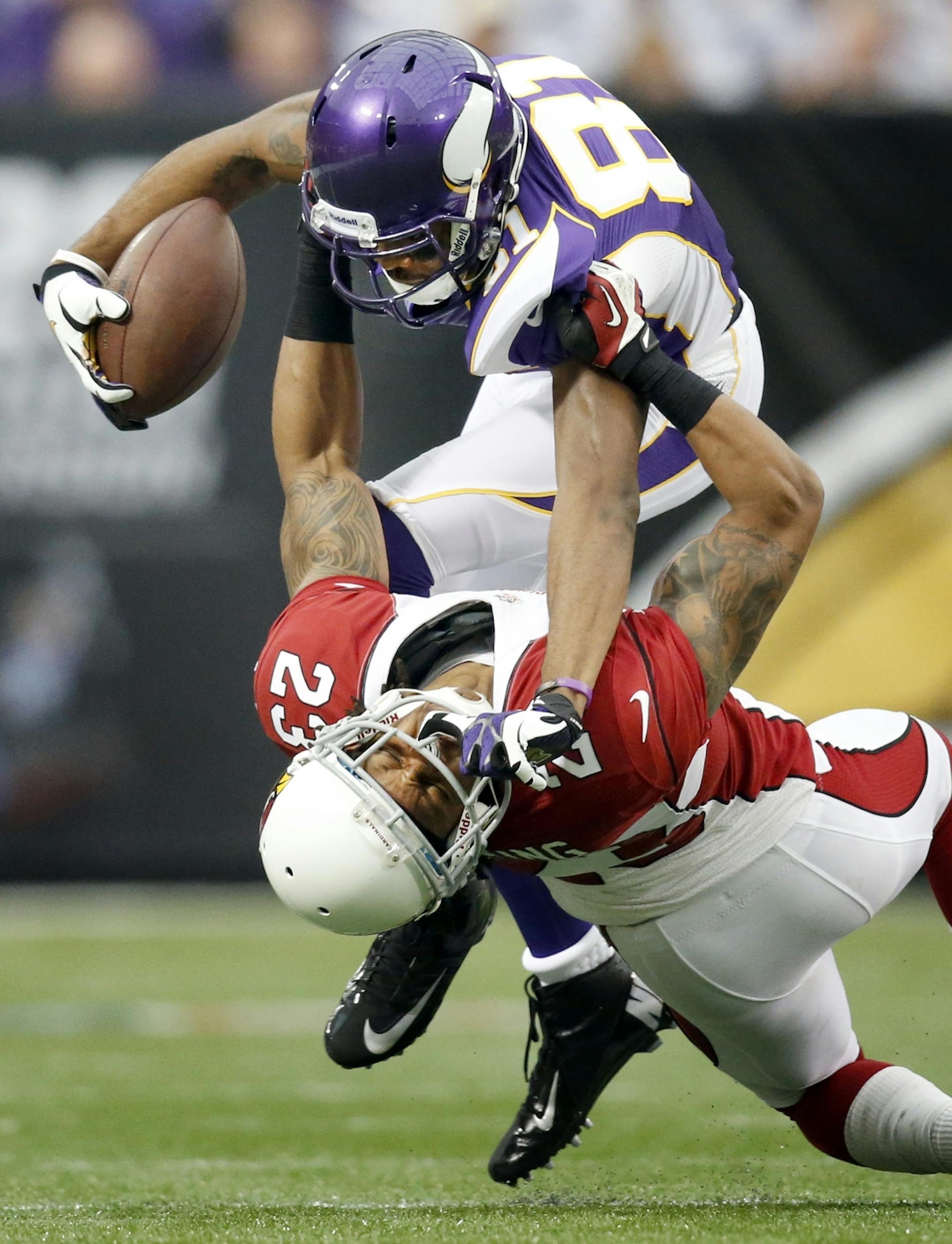 Minnesota Vikings receiver Jerome Simpson (81) was tackled by Jamell Fleming (23) in the first quarter.