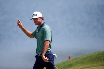 Austin Eckroat greets the crowd on his way to the green at the 18th hole during the final round of the 3M Open at TPC Twin Cities. Eckroat, playing in