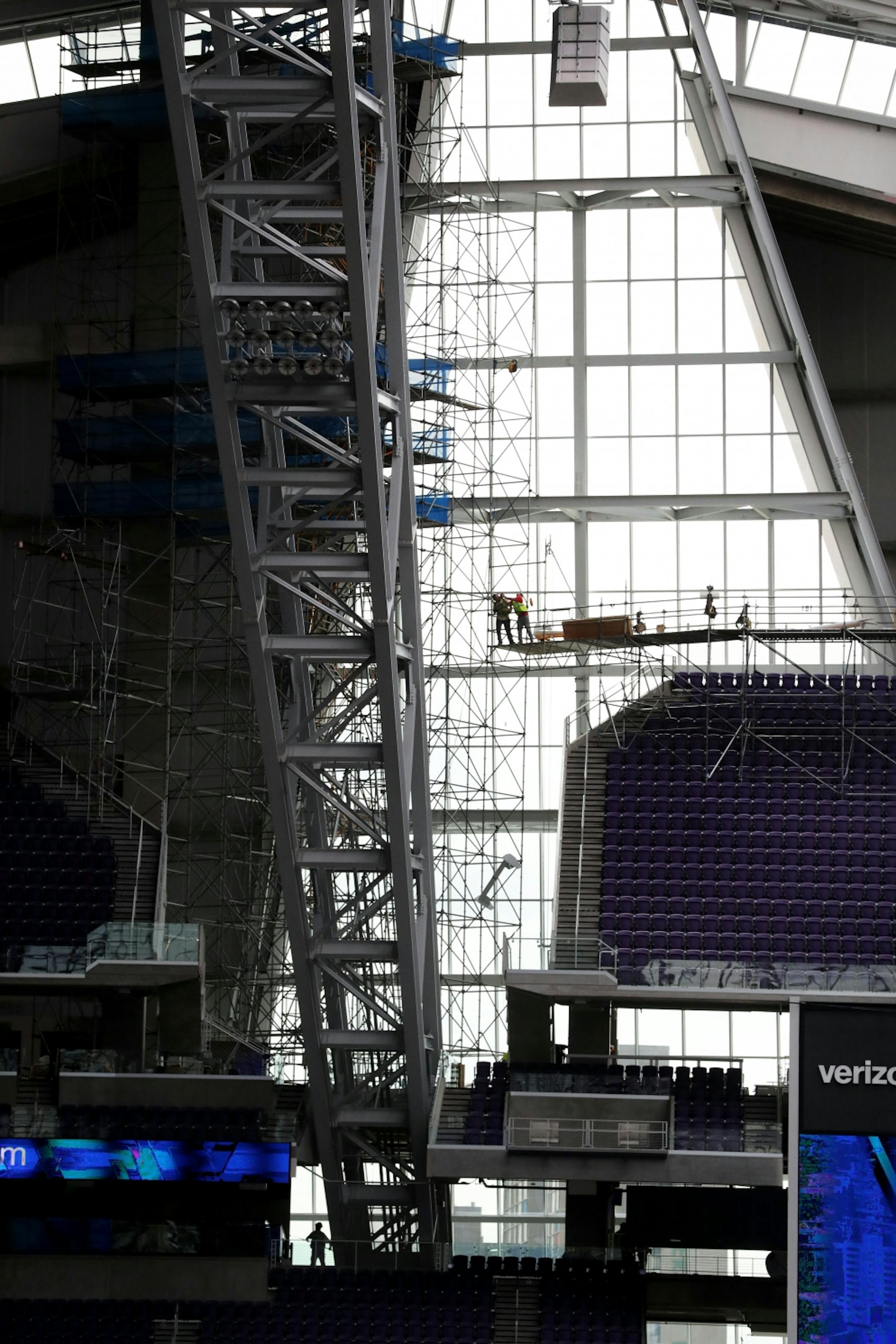 Workers finish up the last of the work during a media tour Tuesday, July 19, 2016, at U.S. Bank Stadium in Minneapolis, MN.